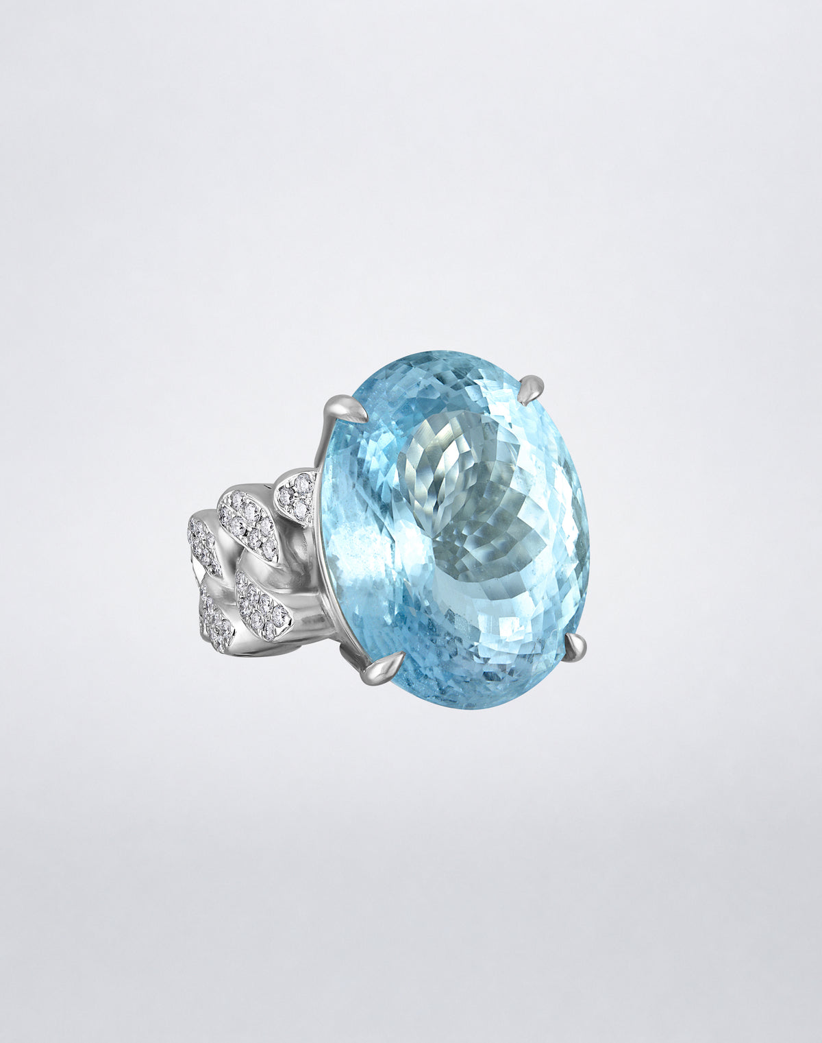 Angled view of the Mindi Mond New York Aquamarine and Diamond Link Ring in 18K white gold with an oval aquamarine and diamond link detailing.