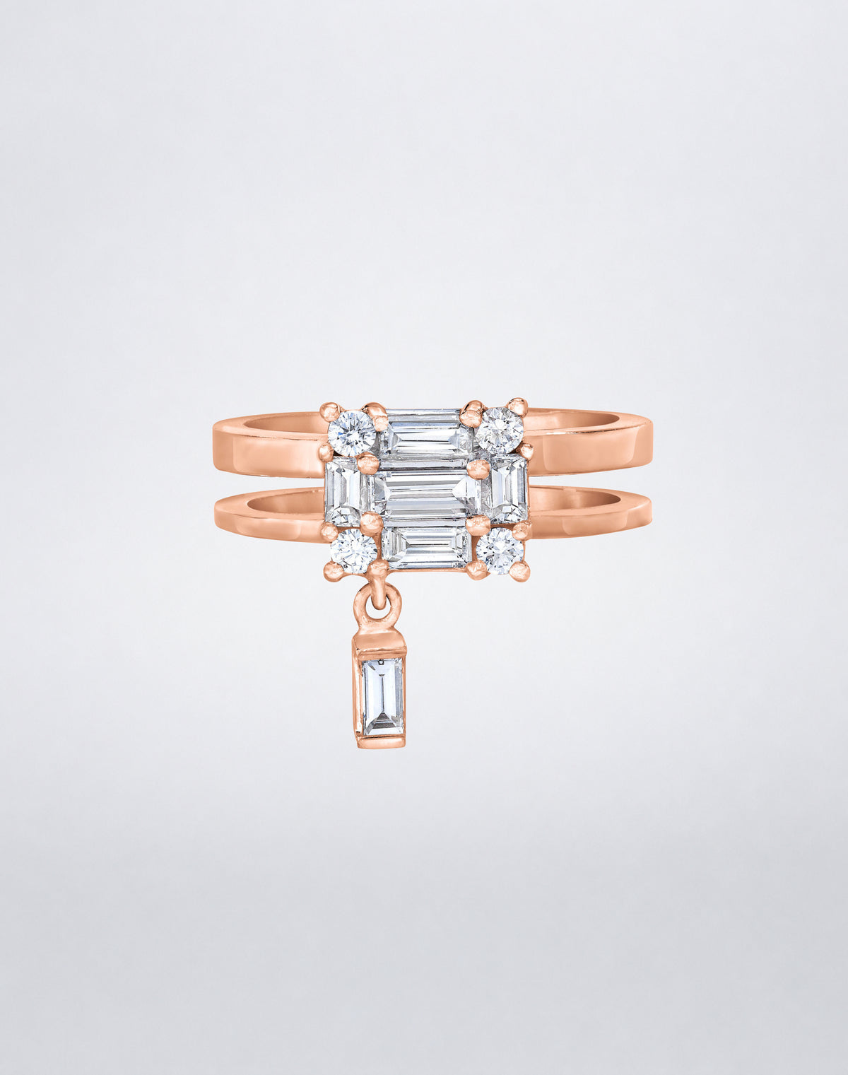 CLARITY³ Dangling Double Shank Ring in 18K rose gold, featuring a square cluster of baguette and round diamonds with a dangling baguette diamond below, shown at an angle, by Mindi Mond New York