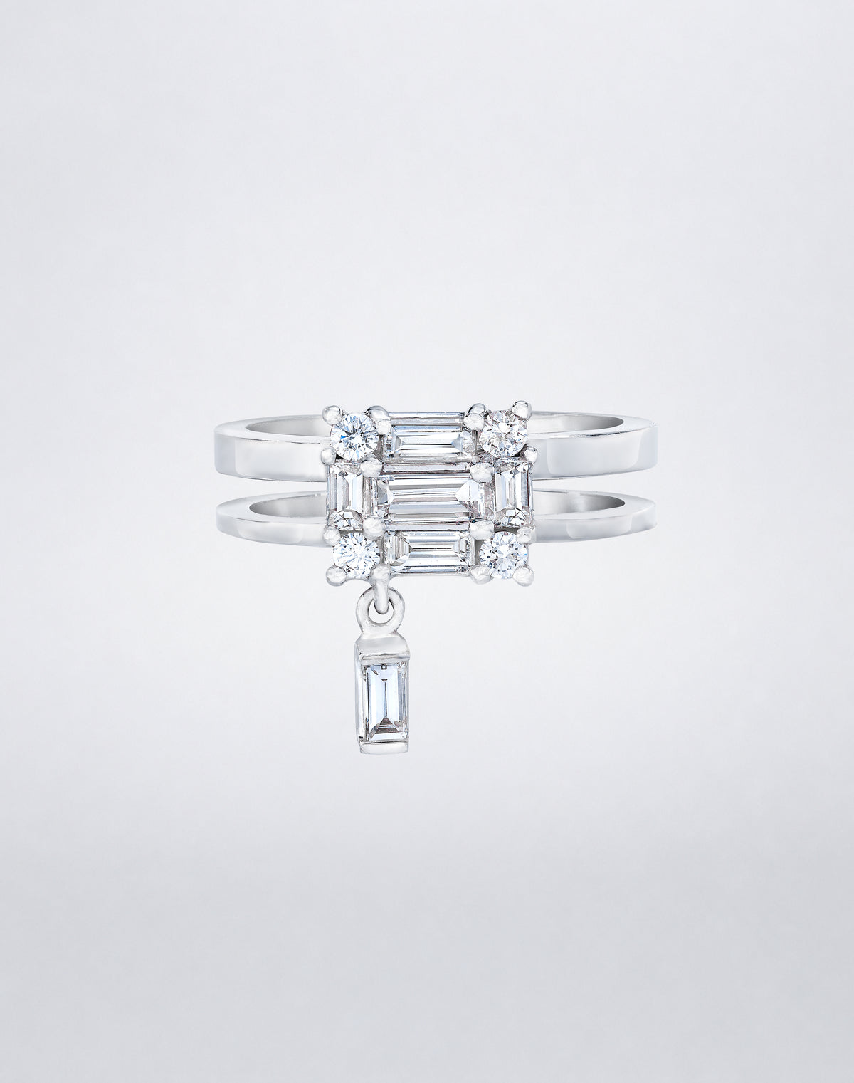 CLARITY³ Dangling Double Shank Ring in 18K white gold, featuring a square cluster of baguette and round diamonds with a dangling baguette diamond below, by Mindi Mond New York
