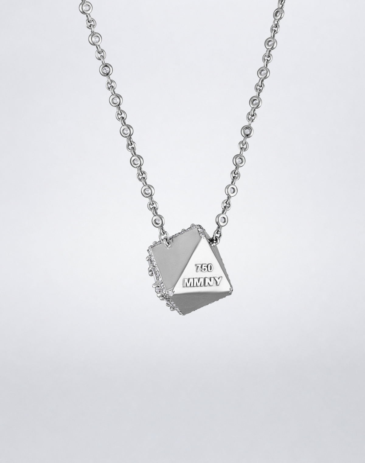 Mindi Mond New York Clarity³ Dimensional Halo Cube Necklace in 18K white gold, back of the cube showing polished gold faces and MMNY 750 hallmark