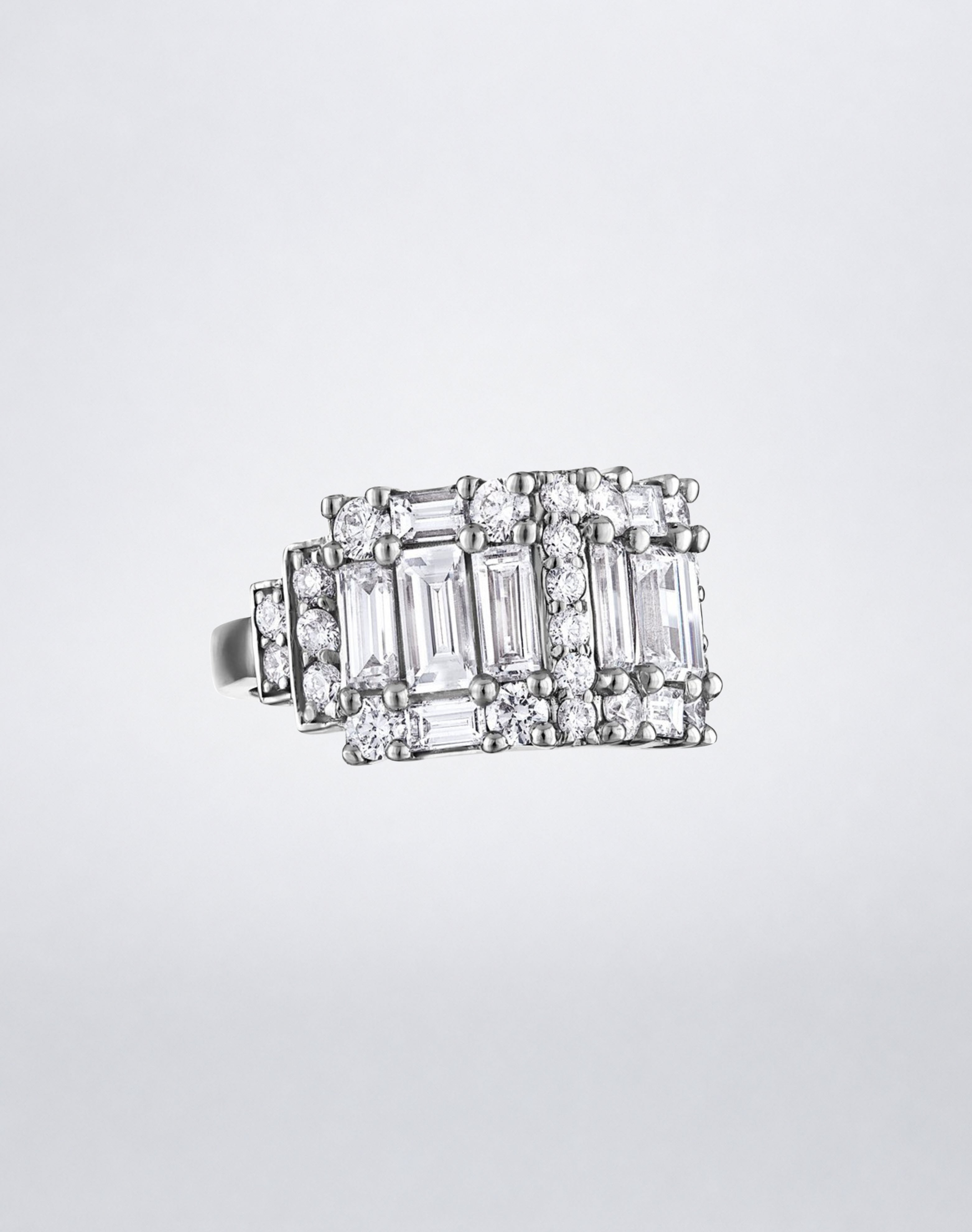 CLARITY³ Step Diamond Band in 18K white gold, featuring alternating columns of baguette and round diamonds, shown at an angle, by Mindi Mond New York