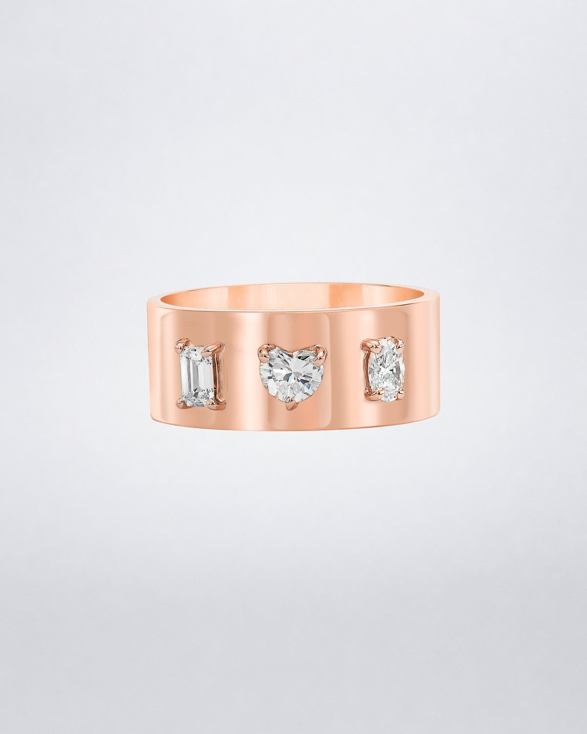 Mindi Mond New York Fancy Cut Cigar Band in 18K rose gold, emerald, heart and oval-cut diamonds claw-set into a wide high-polish band