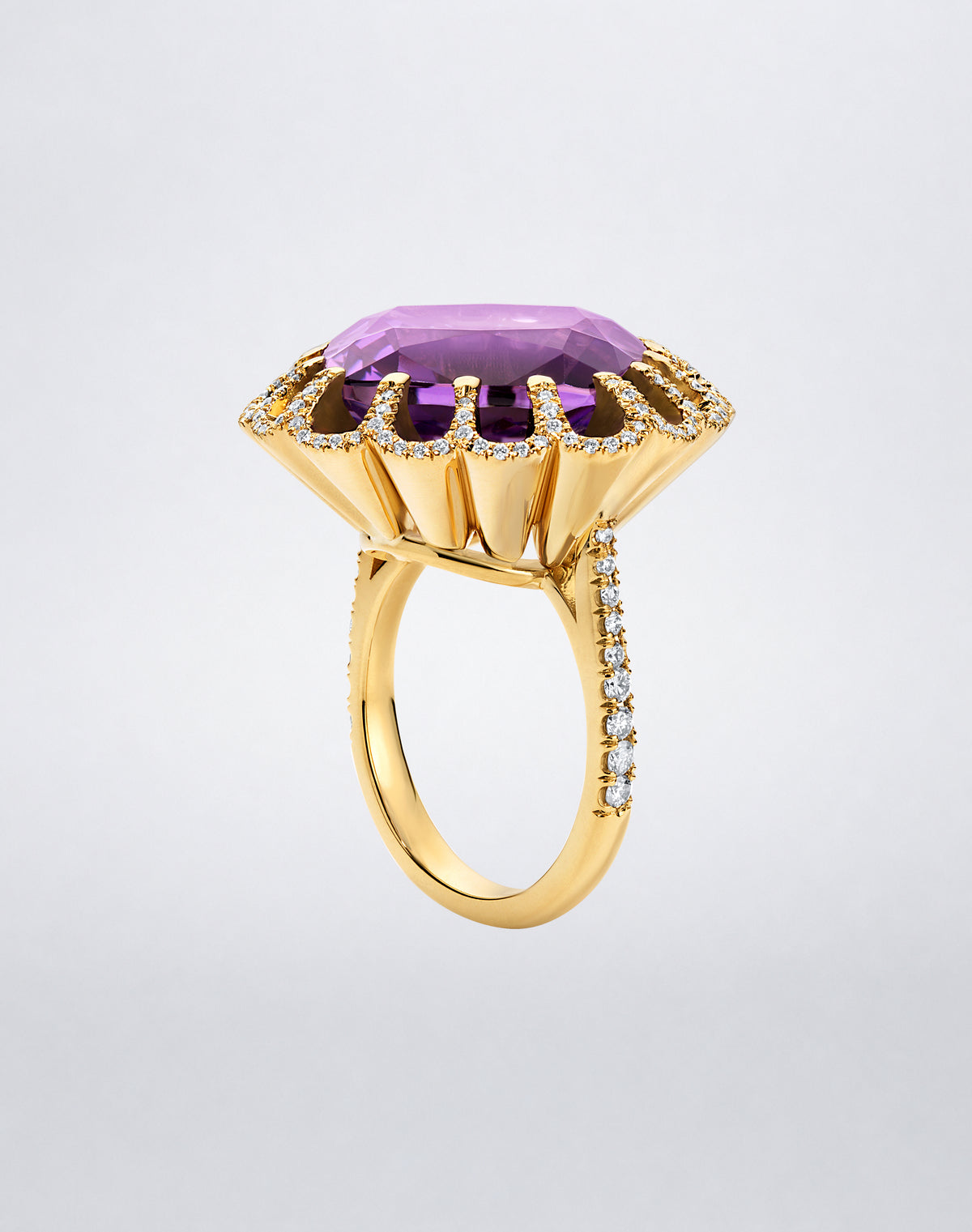 Side view of the Mindi Mond New York FLOATING HUES Amethyst and Diamond Ring in 18K yellow gold, highlighting the raised iconic elliptical setting and diamond band.