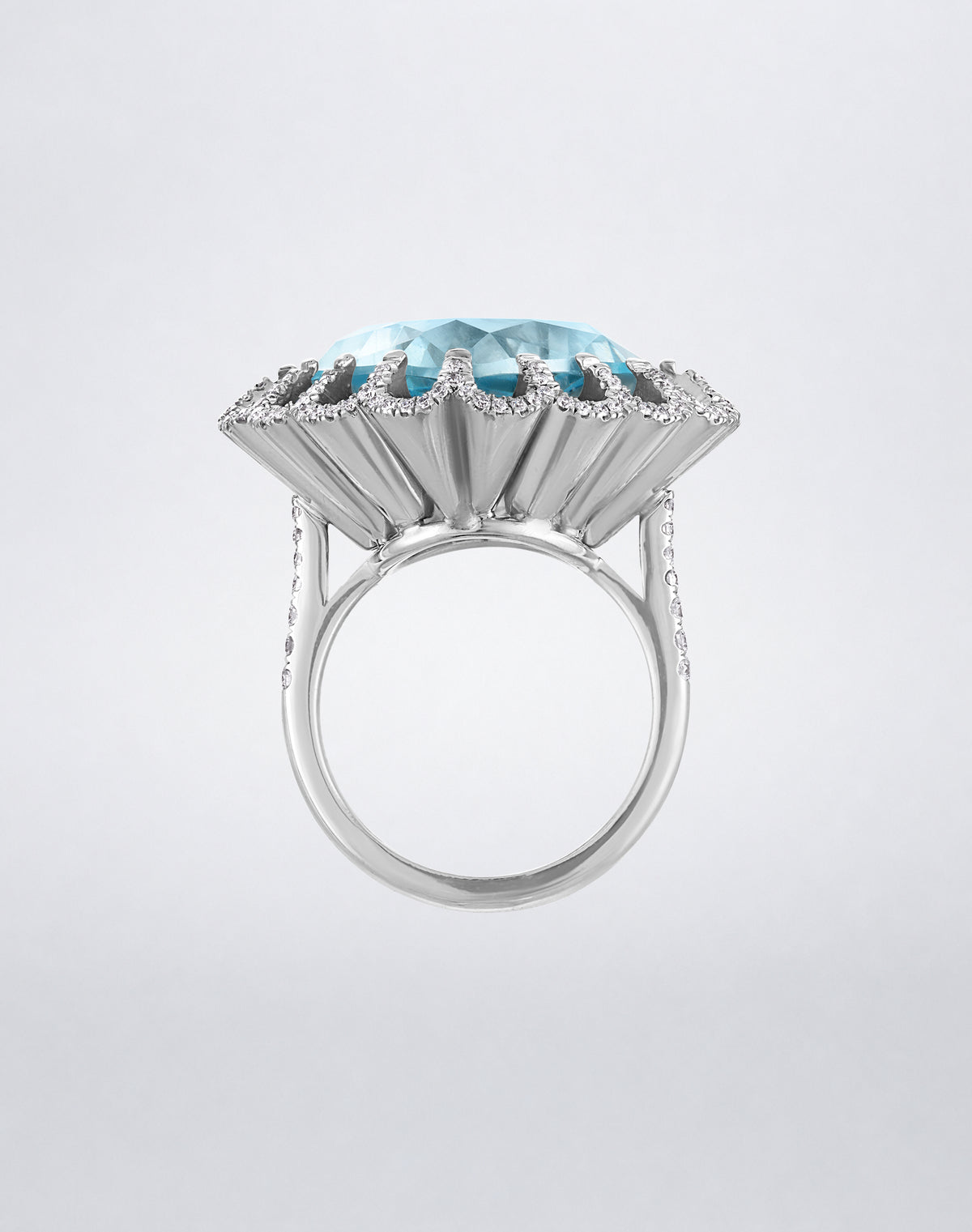 Side view of the Mindi Mond New York FLOATING HUES Aquamarine and Diamond Ring in 18K white gold, highlighting the raised iconic elliptical setting.