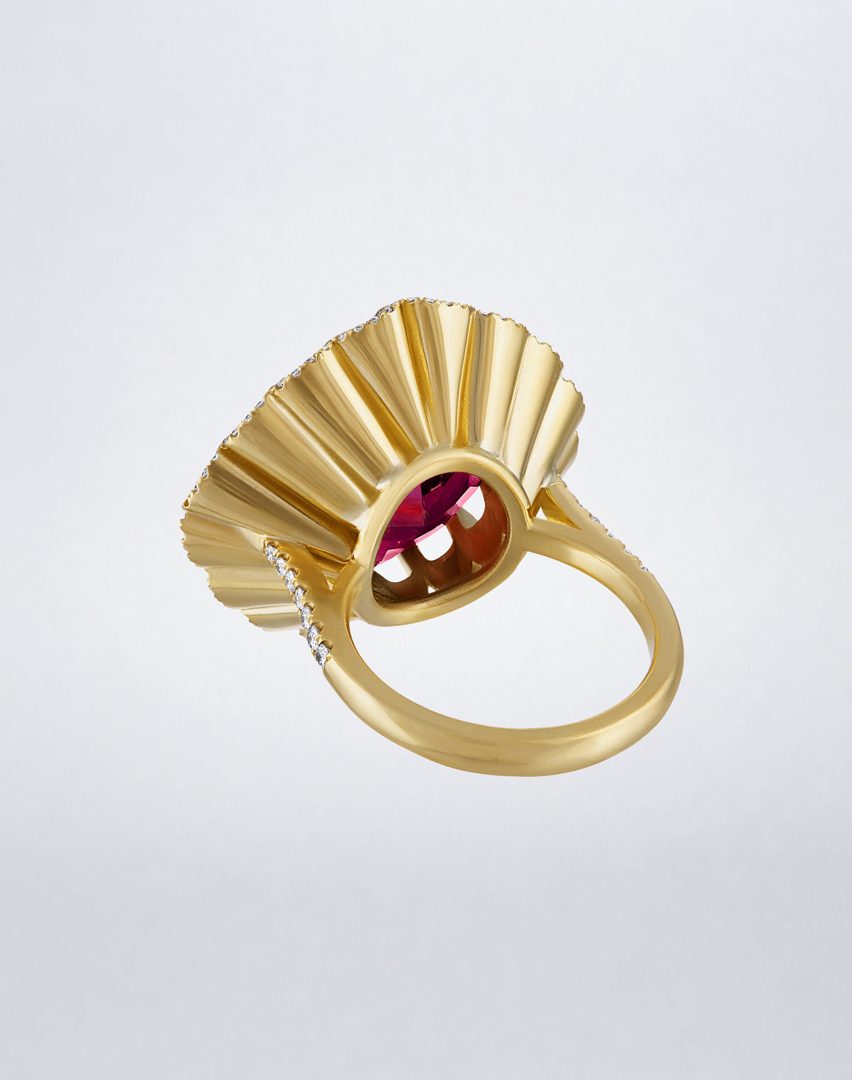 Underside angled view of the Mindi Mond New York FLOATING HUES Rhodolite Garnet and Diamond Ring in 18K yellow gold, highlighting the sculptural iconic elliptical setting.