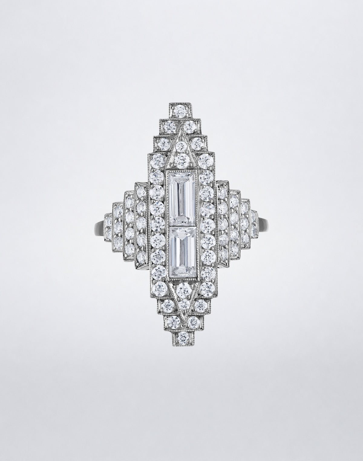 One-of-a-kind All Diamond Empire Ring featuring a symmetrical Art Deco design with stepped rows of round diamonds and central baguette diamonds.