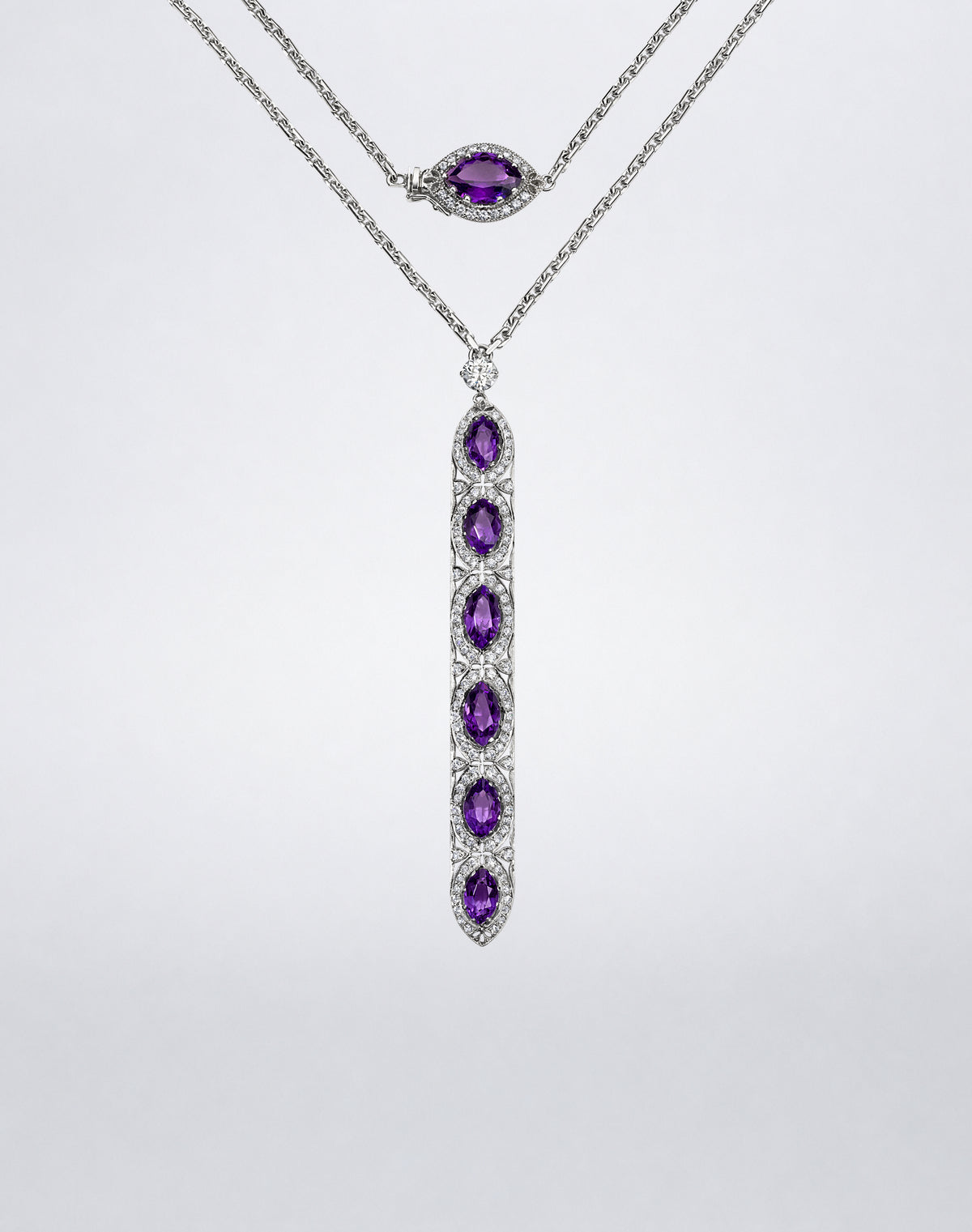 Amethyst and diamond double wrap sautoir with a long articulated pendant of oval amethysts and a coordinating amethyst-set clasp.
