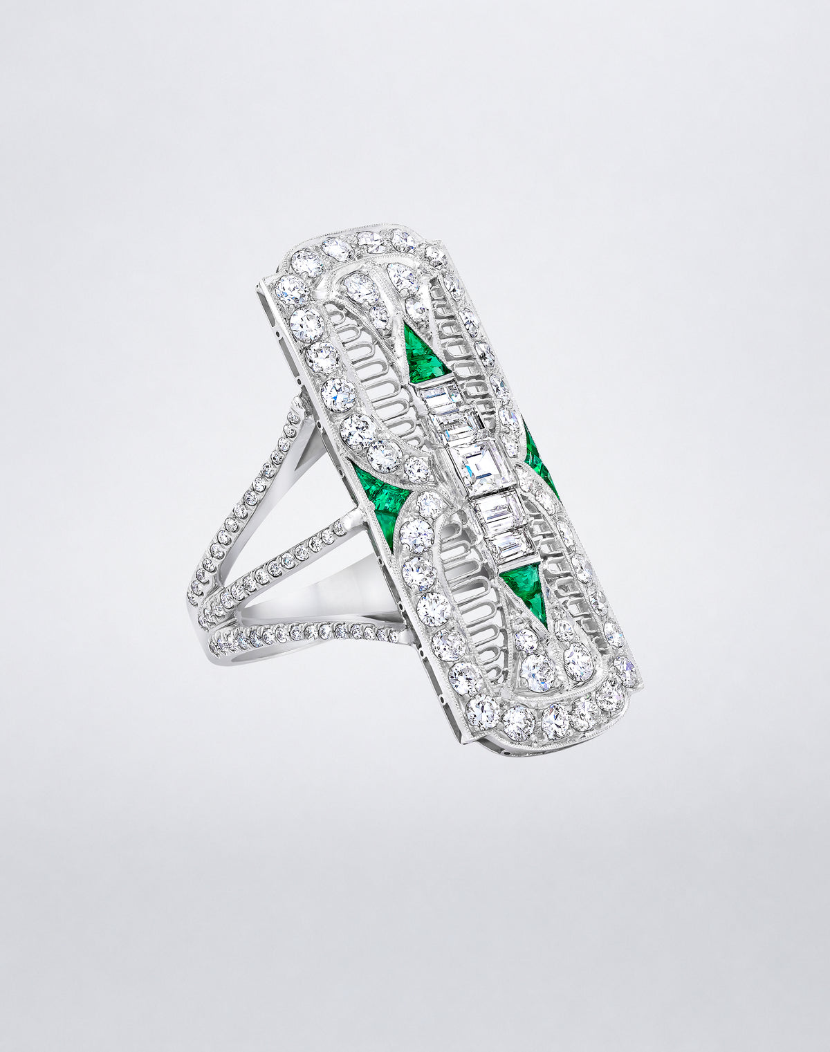Angled view of the one-of-a-kind Platinum Filigree Emerald and Diamond Cocktail Ring showing the openwork platinum setting with geometric emeralds and diamonds.