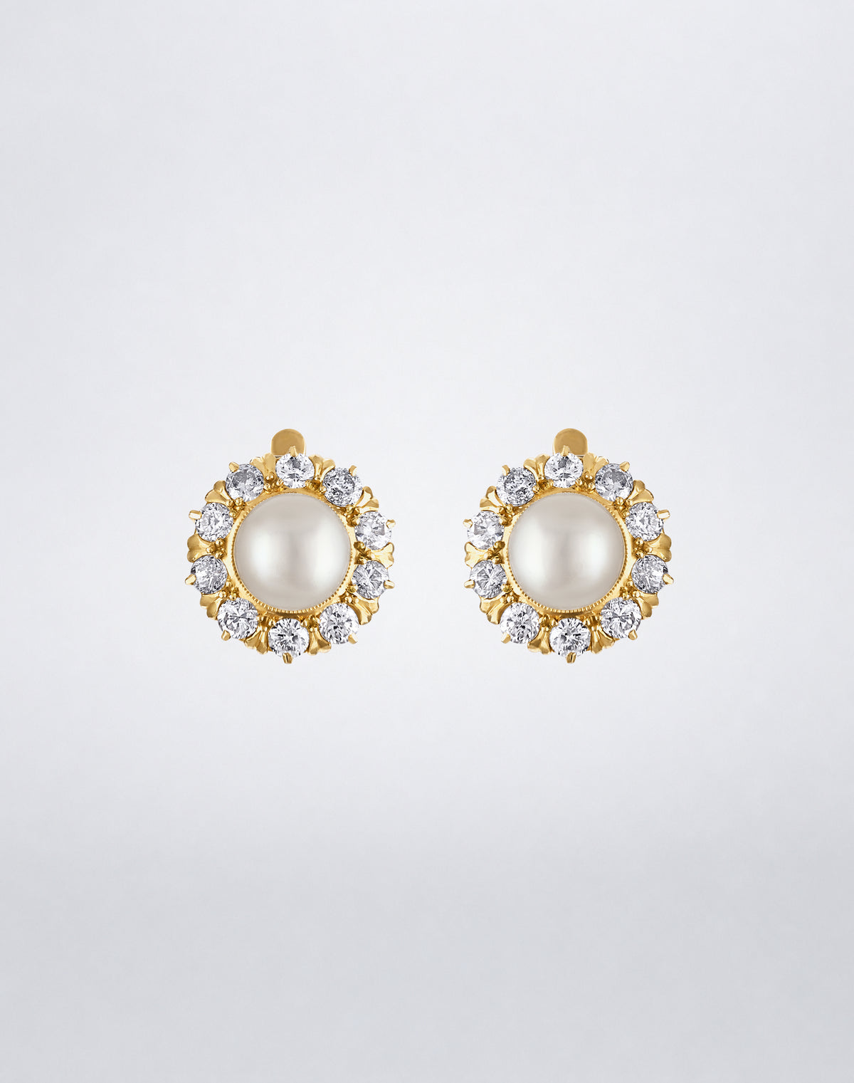 One-of-a-kind Victorian pearl and old European diamond earrings featuring central white pearls encircled by old European-cut diamonds in yellow gold, front view