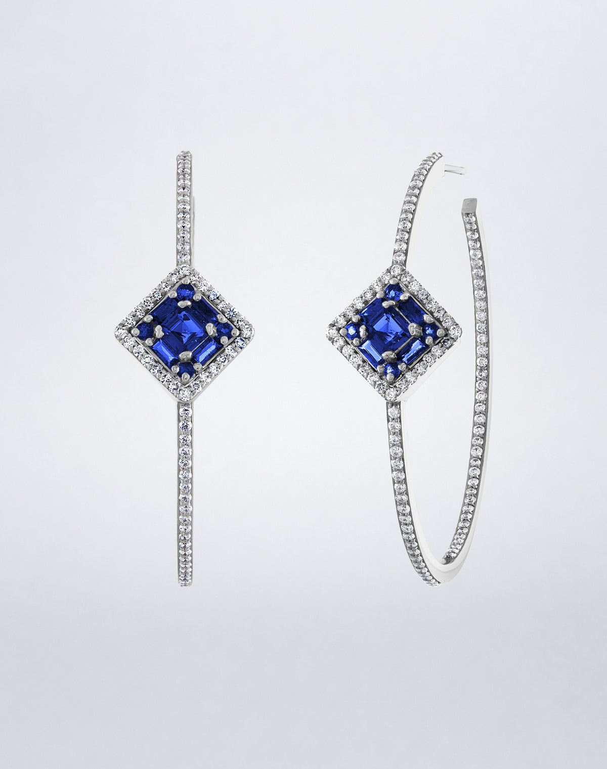Mindi Mond New York Clarity³ Sapphire Asscher Cut Hoops in 18K white gold, an Asscher-cut blue sapphire formation set in a diamond halo on a slender pavé hoop