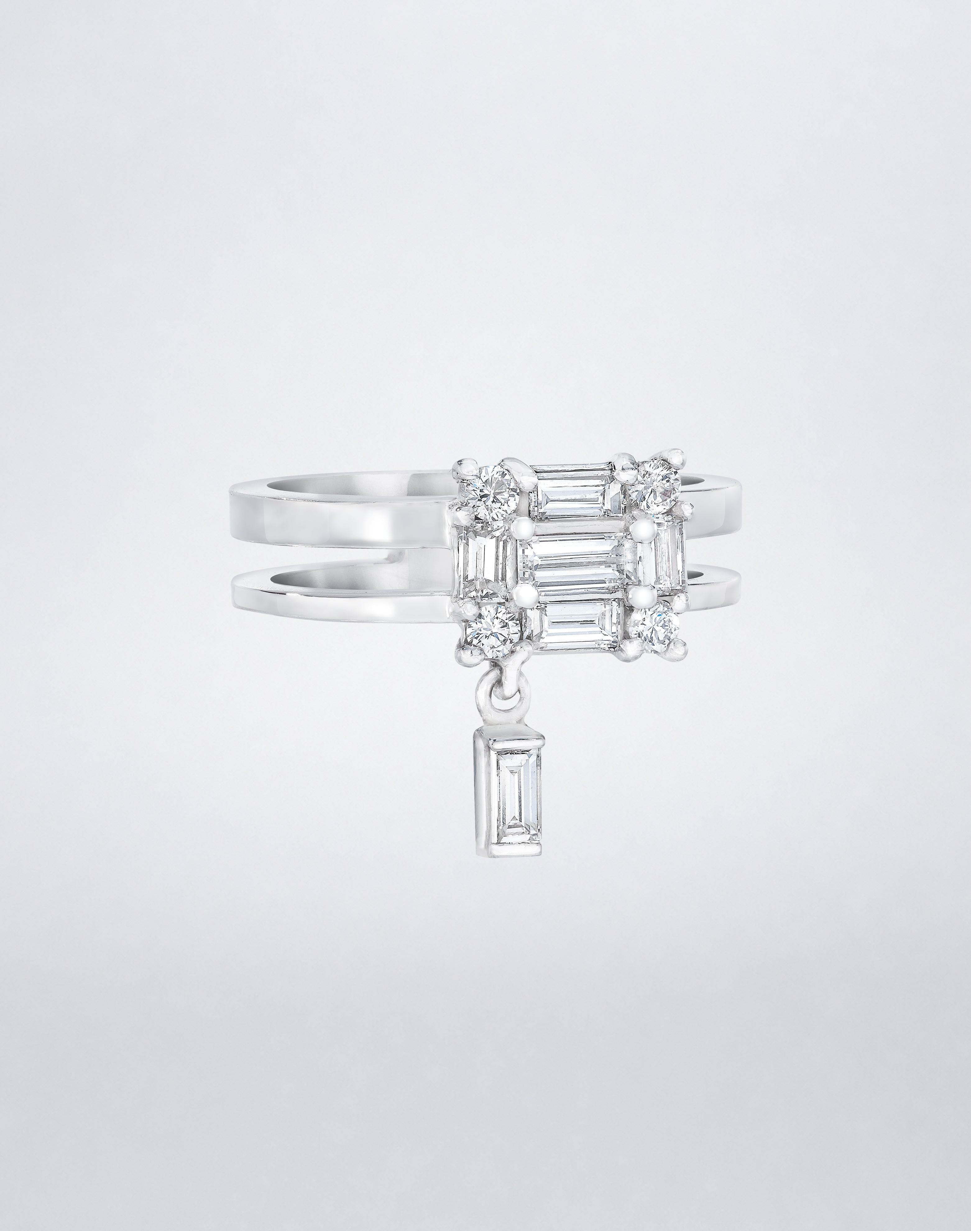 CLARITY³ Dangling Double Shank Ring in 18K white gold, featuring a square cluster of baguette and round diamonds with a dangling baguette diamond below, shown at an angle, by Mindi Mond New York