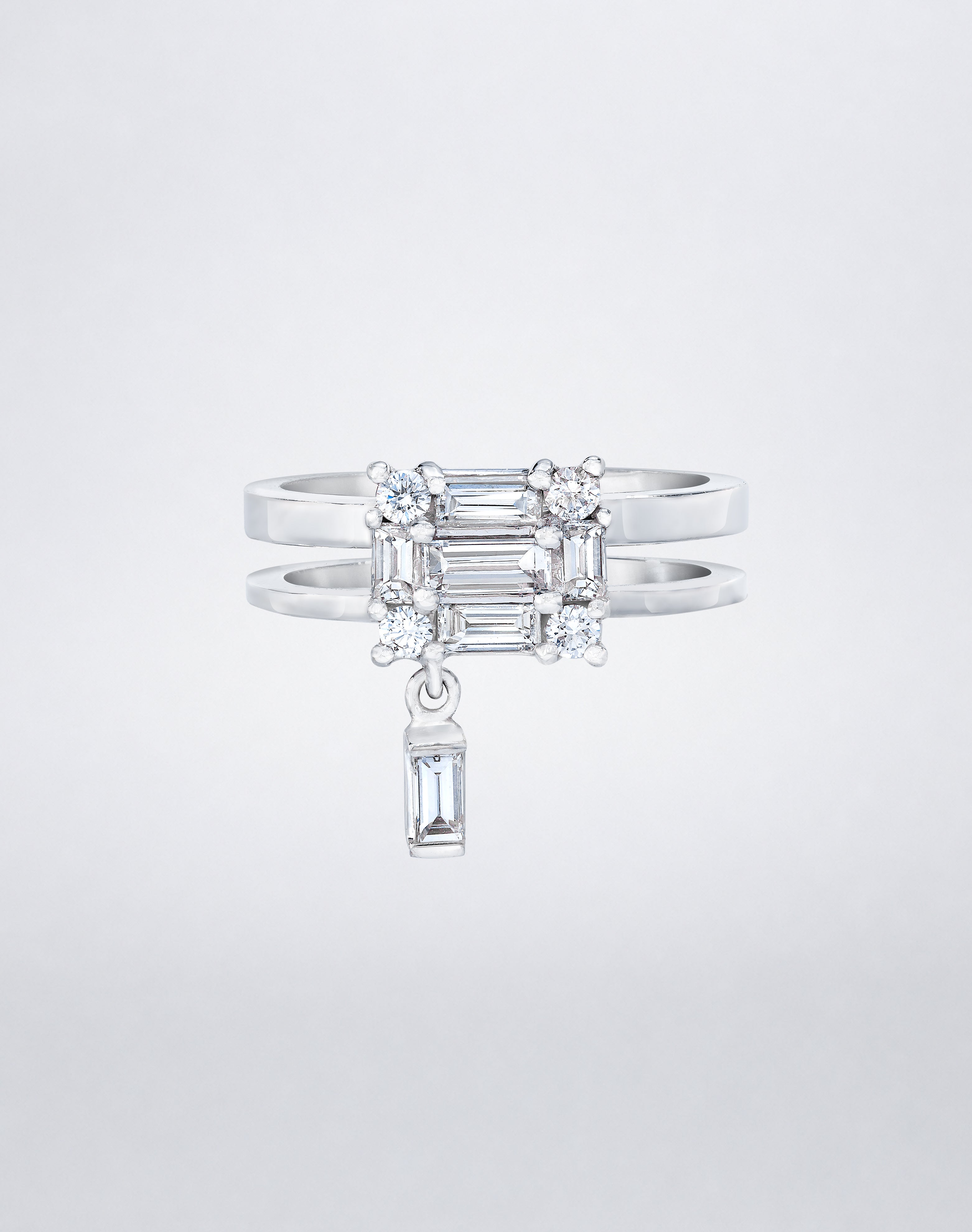 CLARITY³ Dangling Double Shank Ring in 18K white gold, featuring a square cluster of baguette and round diamonds with a dangling baguette diamond below, by Mindi Mond New York