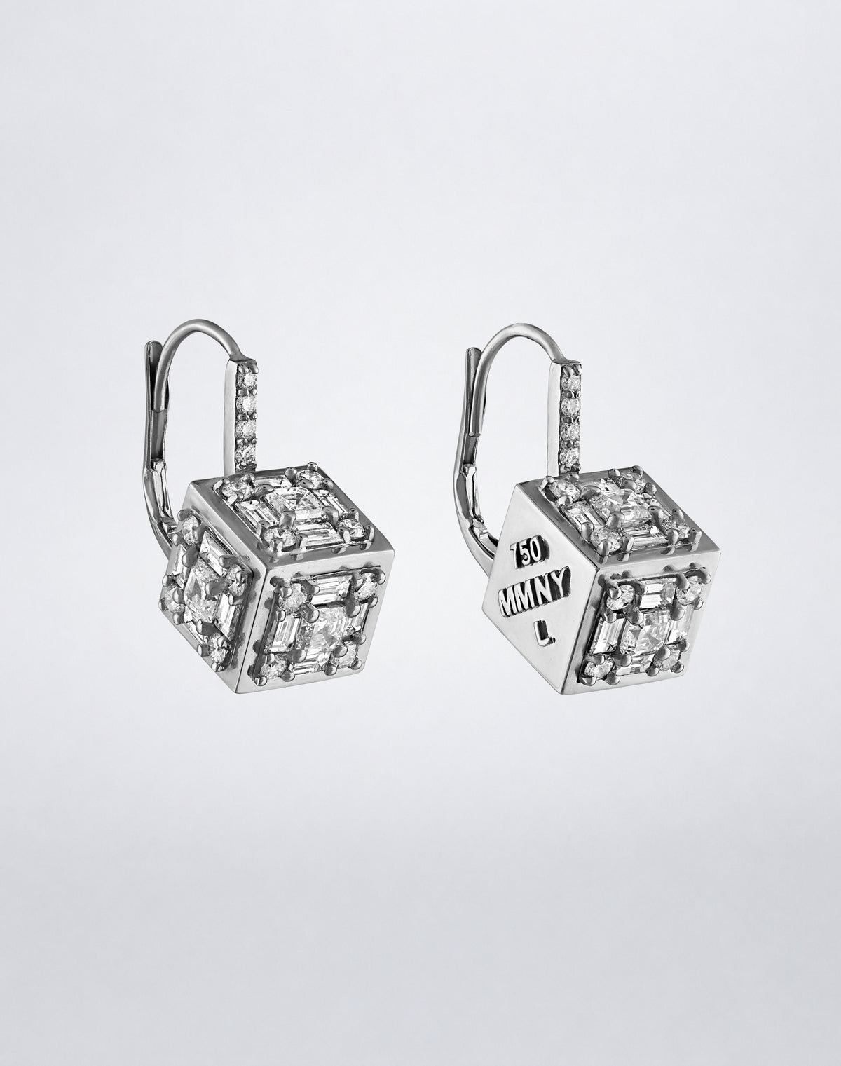 Clarity³ Dimensional Drop Earrings in 18K white gold, the engraved MMNY face turned toward the light beside diamond-set faces