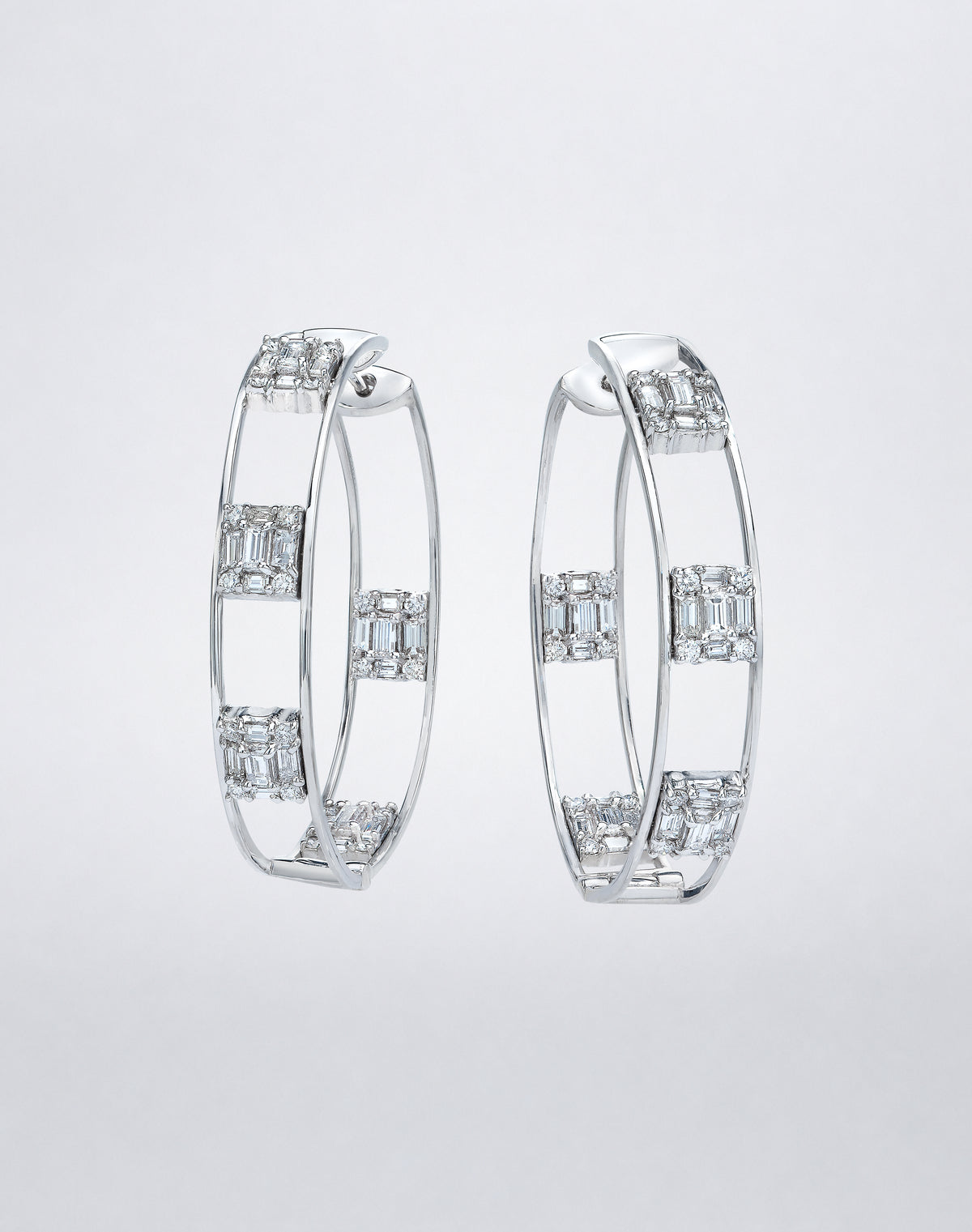 Mindi Mond New York Clarity³ Polished Gold Hoops in 18K white gold, nine-stone diamond formations set at intervals around a slender polished double-rail hoop