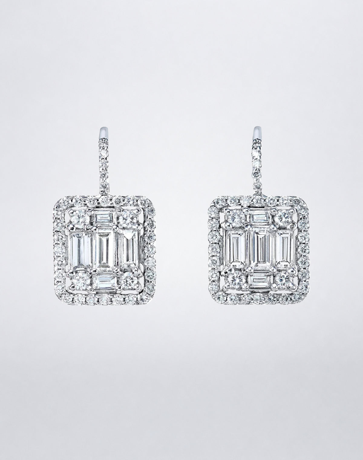 Mindi Mond New York Clarity³ Mega Halo Earrings in 18K white gold, an enlarged nine-stone diamond formation framed in a diamond halo on a pavé lever-back