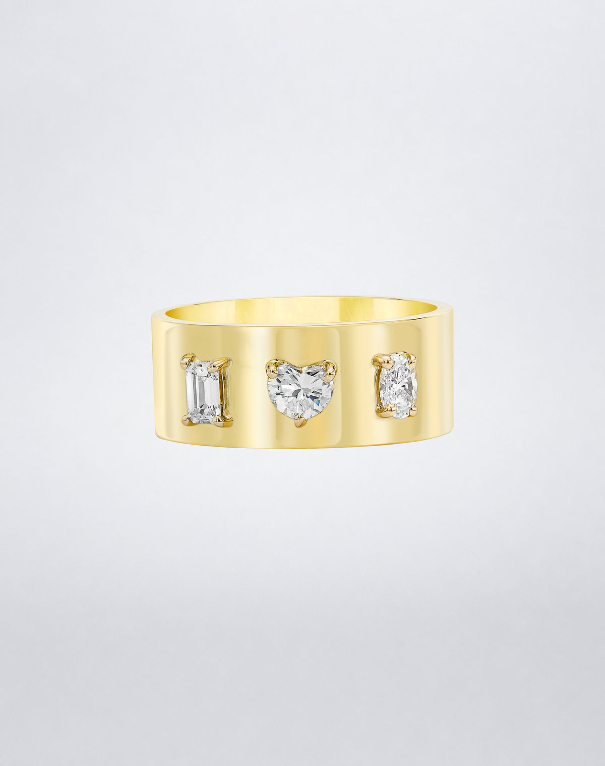 Mindi Mond New York Fancy Cut Cigar Band in 18K yellow gold, emerald, heart and oval-cut diamonds claw-set into a wide high-polish band