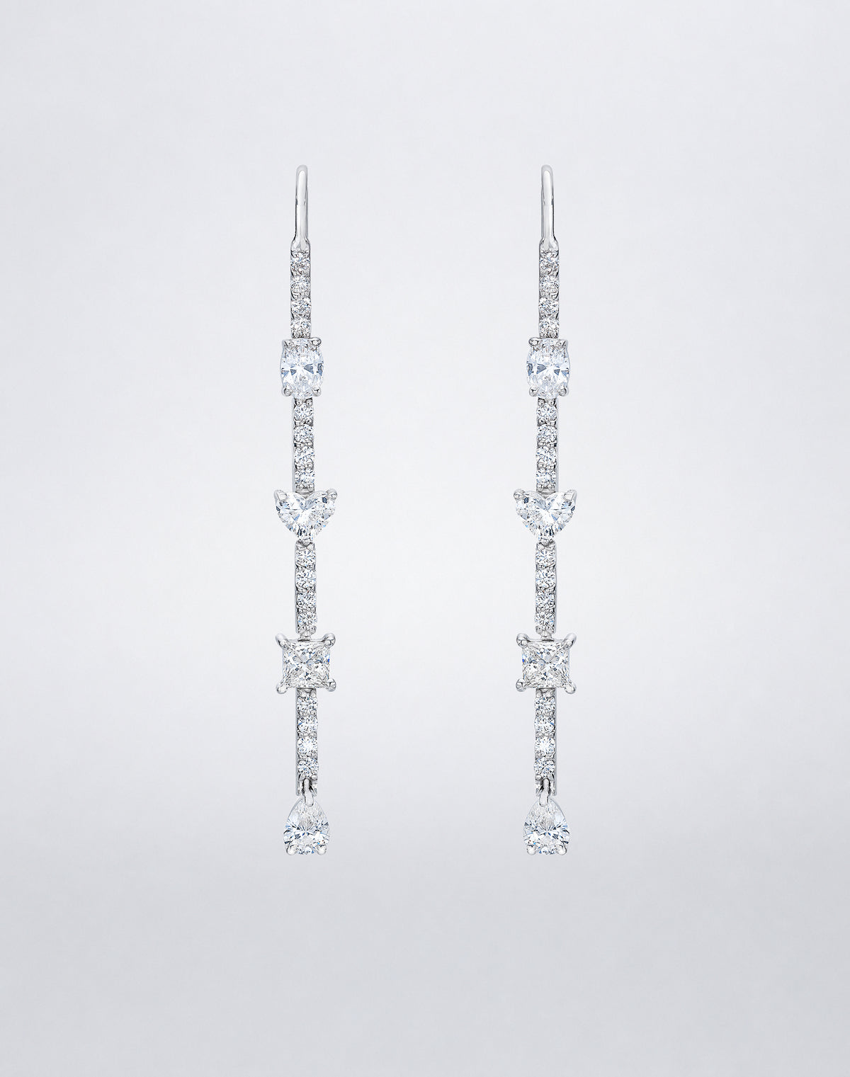 Mindi Mond New York Fancy Cut Dangling Earrings in 18K white gold, oval, heart, princess and pear-cut diamonds spaced along a slender pavé line on a hook