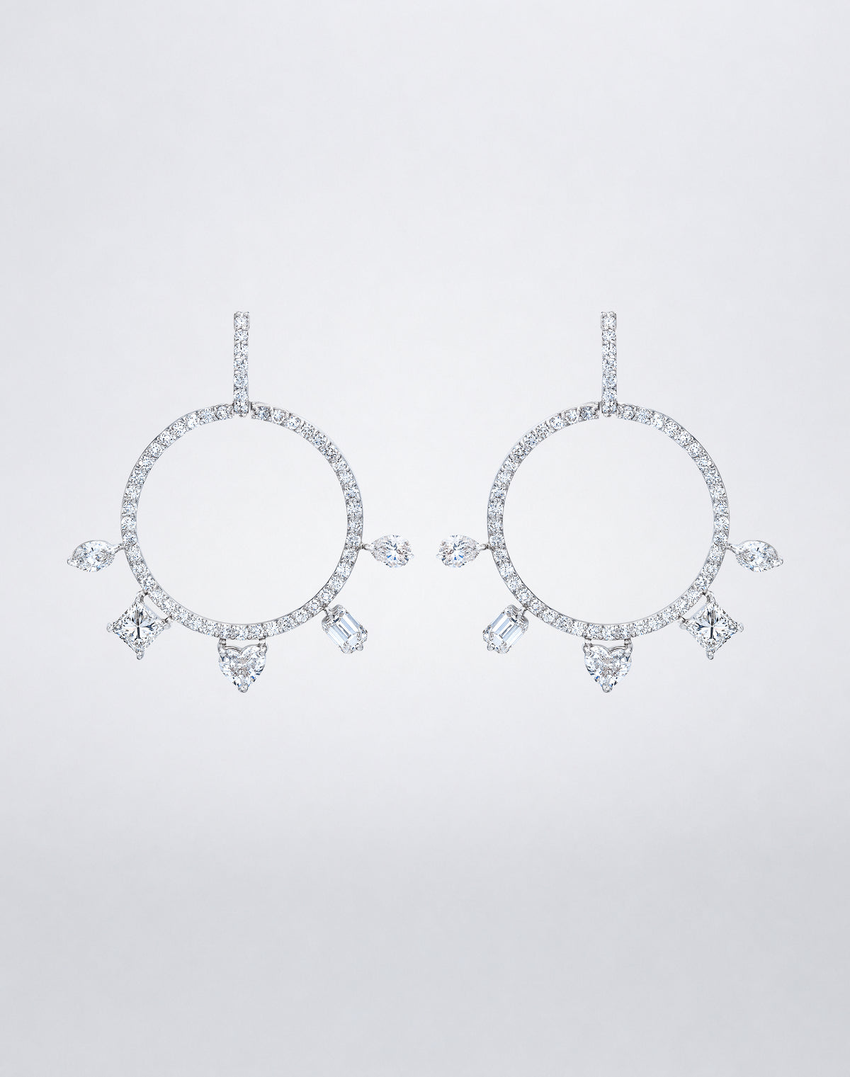 Mindi Mond New York Fancy Cut Gypsy Hoop Earrings in 18K white gold, a pavé diamond circle with marquise, princess, heart, emerald and pear-cut diamonds radiating from its lower edge