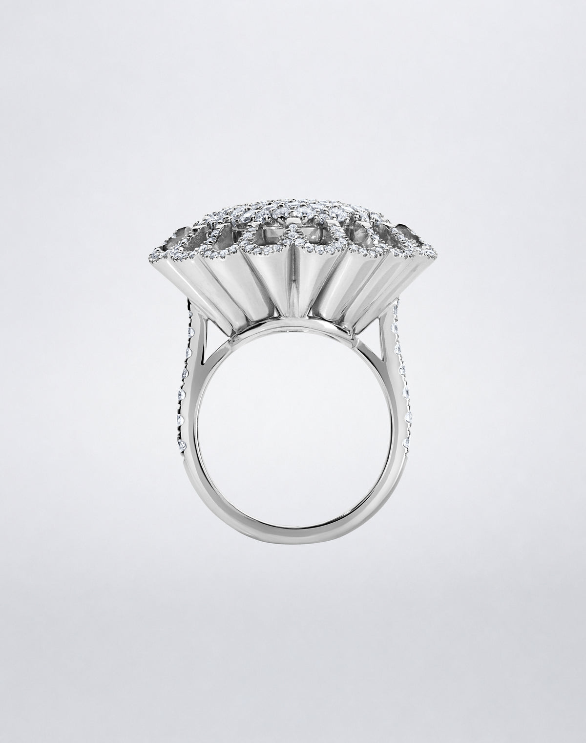 Side view of the Mindi Mond New York FLOATING HUES All Diamond Ring in 18K white gold, highlighting the sculptural iconic elliptical setting.