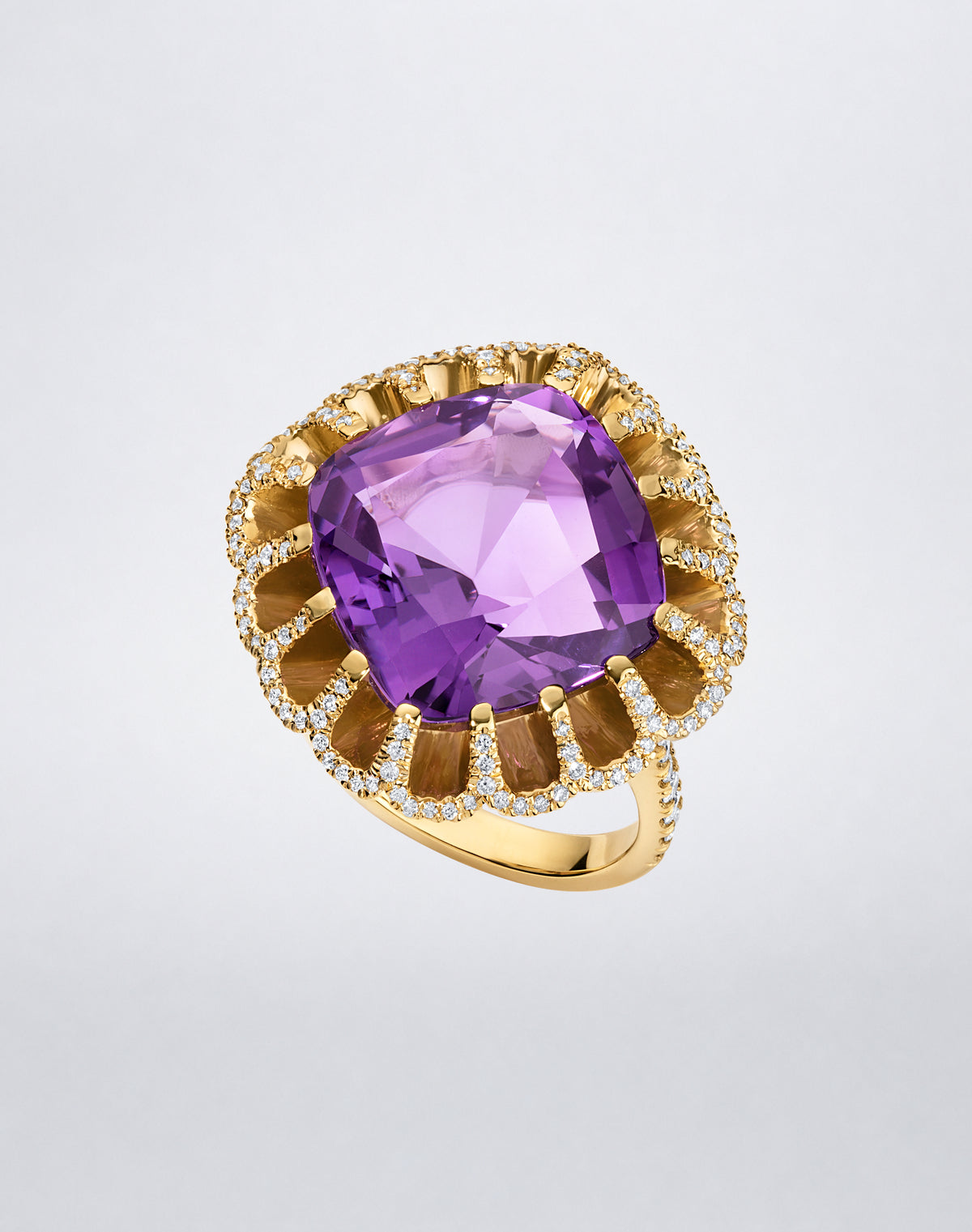 Mindi Mond New York FLOATING HUES Amethyst and Diamond Ring in 18K yellow gold, angled view showcasing a cushion-cut amethyst in the iconic elliptical setting.