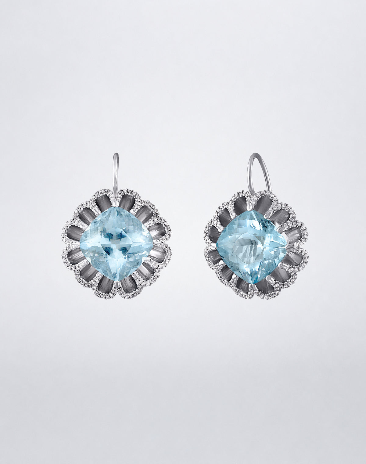 Angled view of Mindi Mond New York Floating Hues Aquamarine and Diamond Drop Earrings with cushion-cut aquamarines and pavé diamonds in 18K white gold