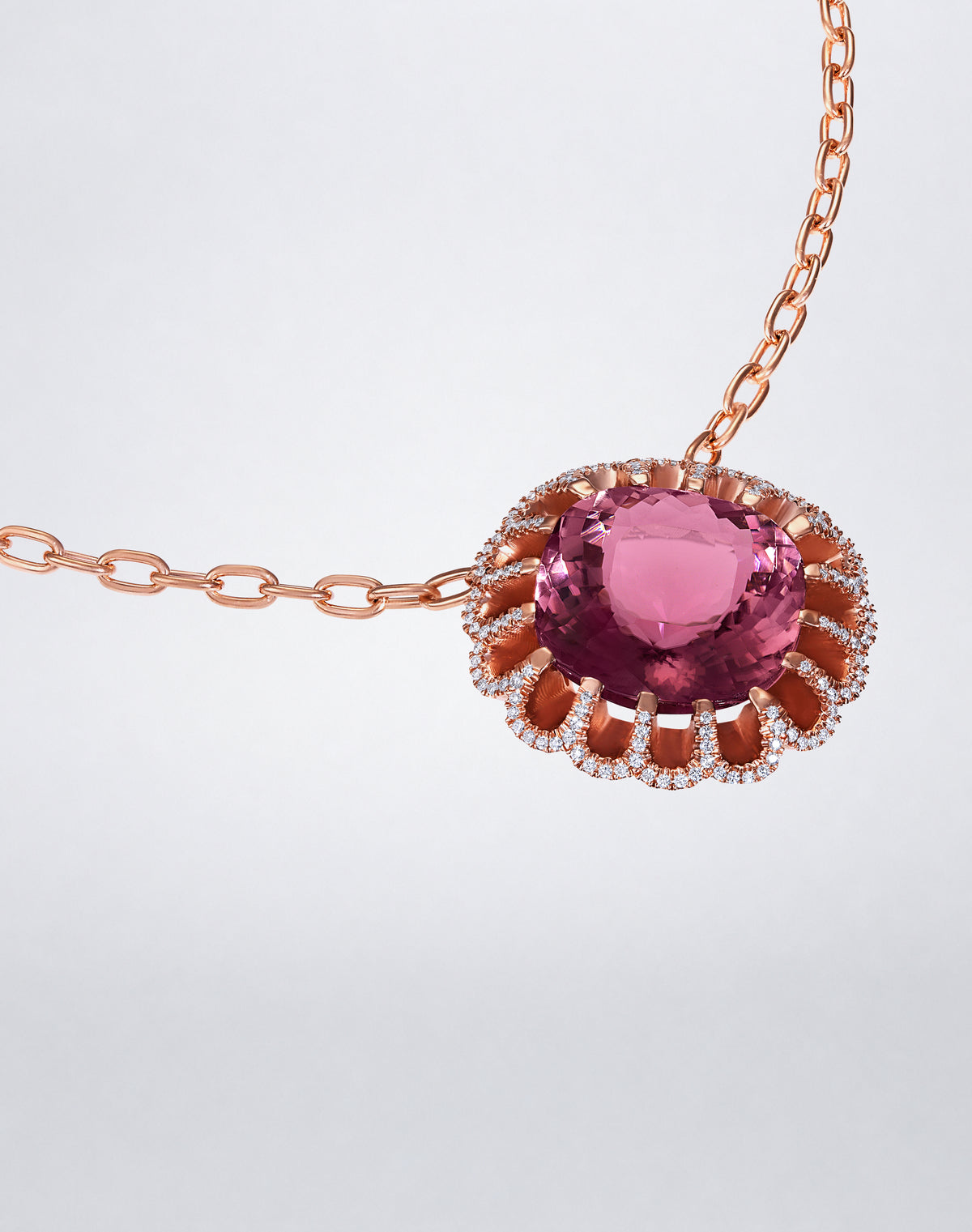 Angled view of Mindi Mond New York Floating Hues Pink Tourmaline and Diamond Necklace with pink tourmaline and pavé diamonds in 18K rose gold