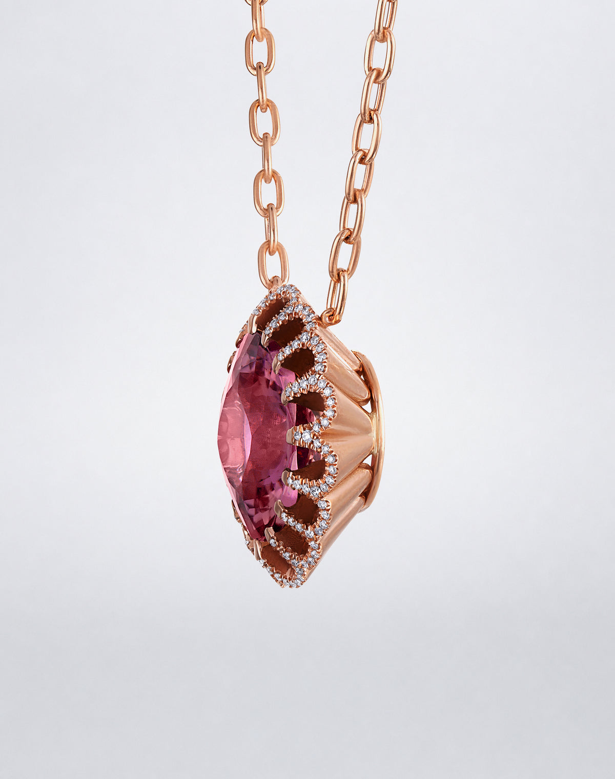 Side view of Mindi Mond New York Floating Hues Pink Tourmaline and Diamond Necklace showing the dimensional elliptical setting in 18K rose gold