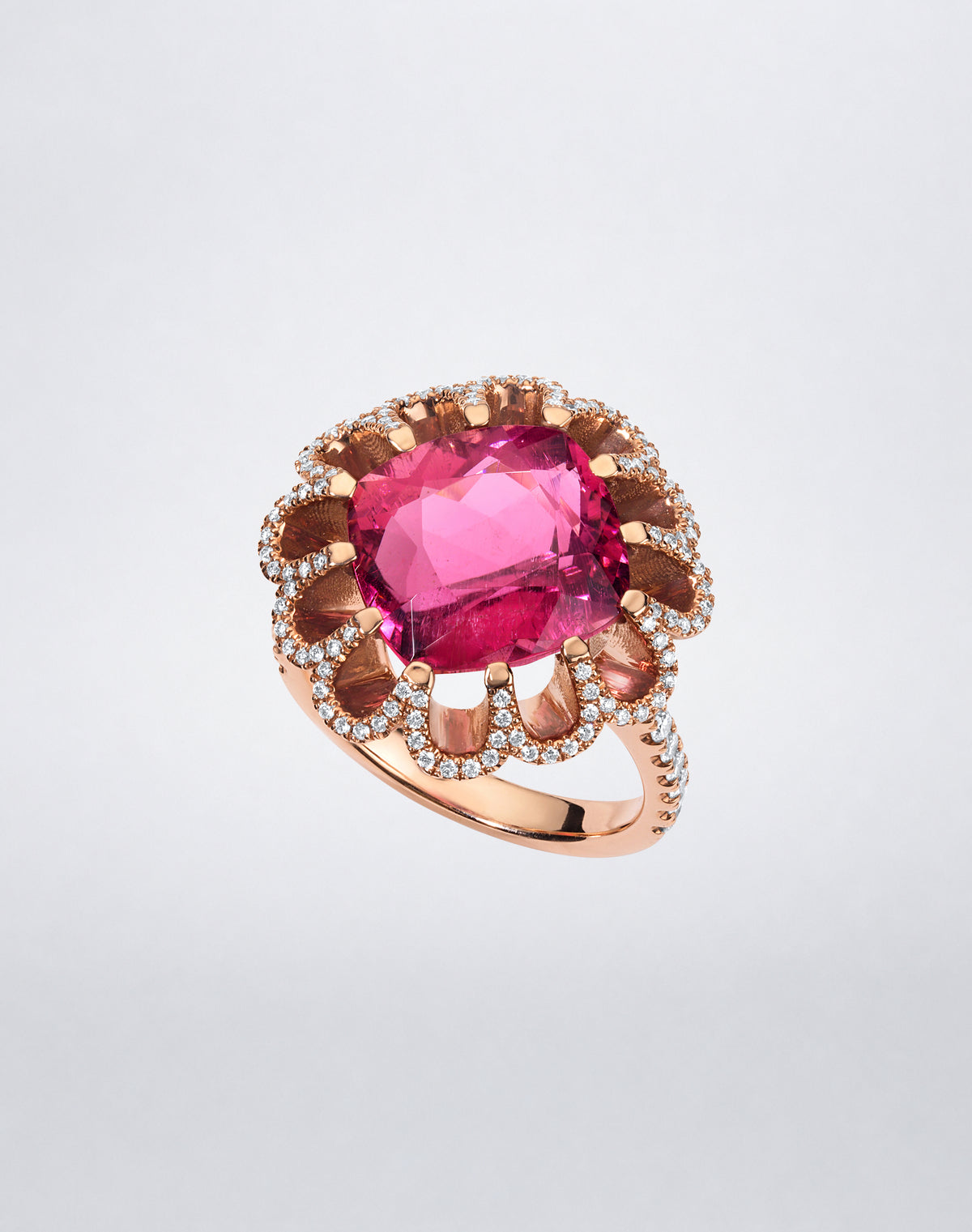 Mindi Mond New York FLOATING HUES Mini Pink Tourmaline and Diamond Ring in 18K rose gold, angled view featuring a cushion-cut pink tourmaline in the iconic elliptical setting.