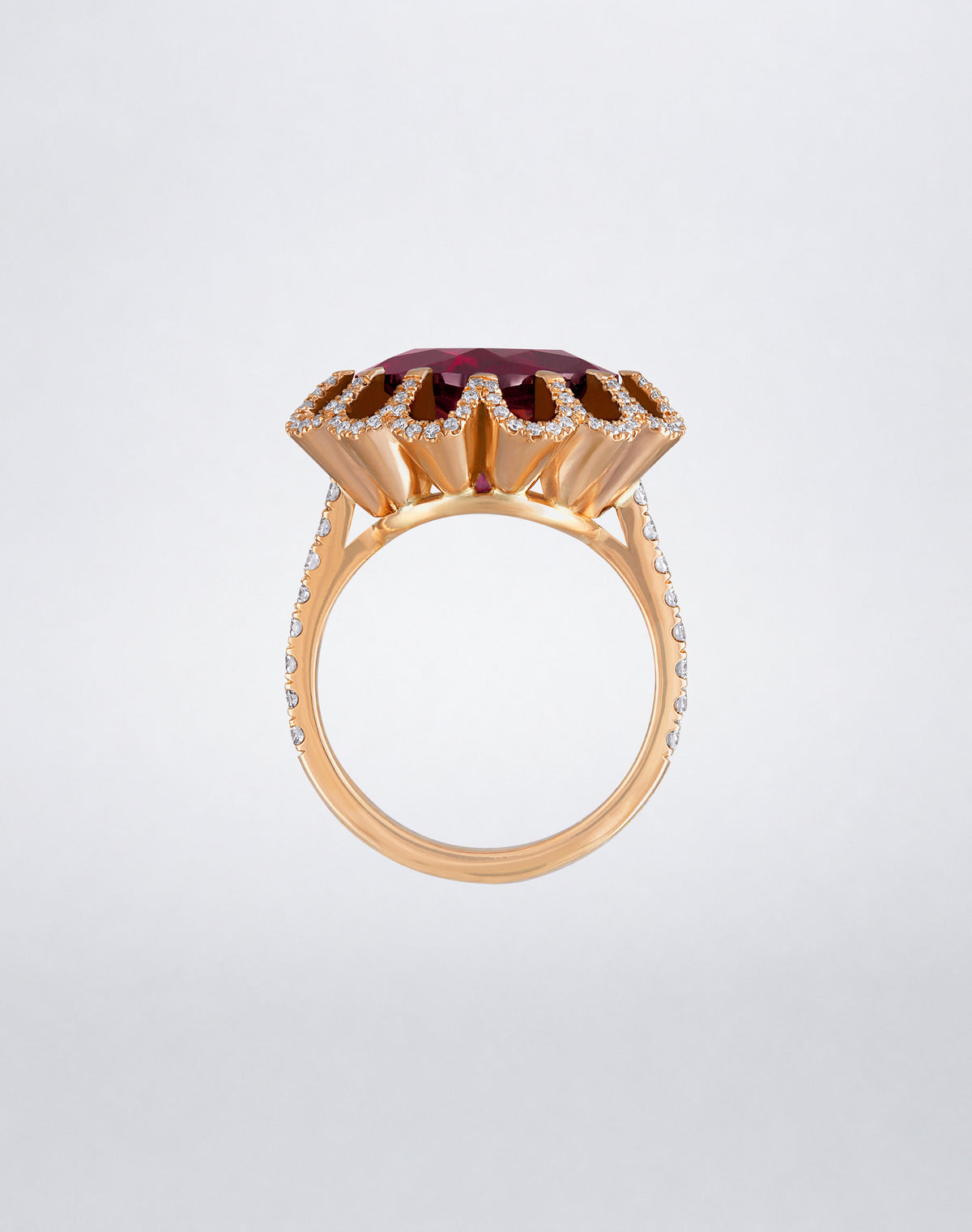 Side view of the Mindi Mond New York FLOATING HUES Rhodolite Garnet and Diamond Petite Ring in 18K rose gold, highlighting the raised iconic elliptical setting.