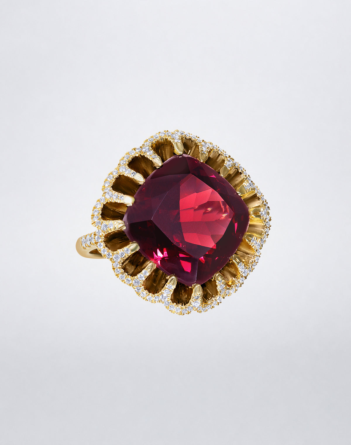 Mindi Mond New York FLOATING HUES Rhodolite Garnet and Diamond Ring in 18K yellow gold, angled view featuring a cushion-cut rhodolite garnet in the iconic elliptical setting.