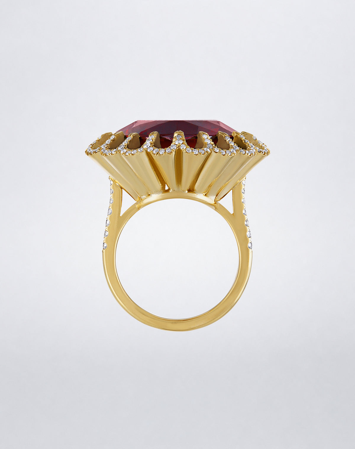 Side view of the Mindi Mond New York FLOATING HUES Rhodolite Garnet and Diamond Ring in 18K yellow gold, highlighting the raised iconic elliptical setting.