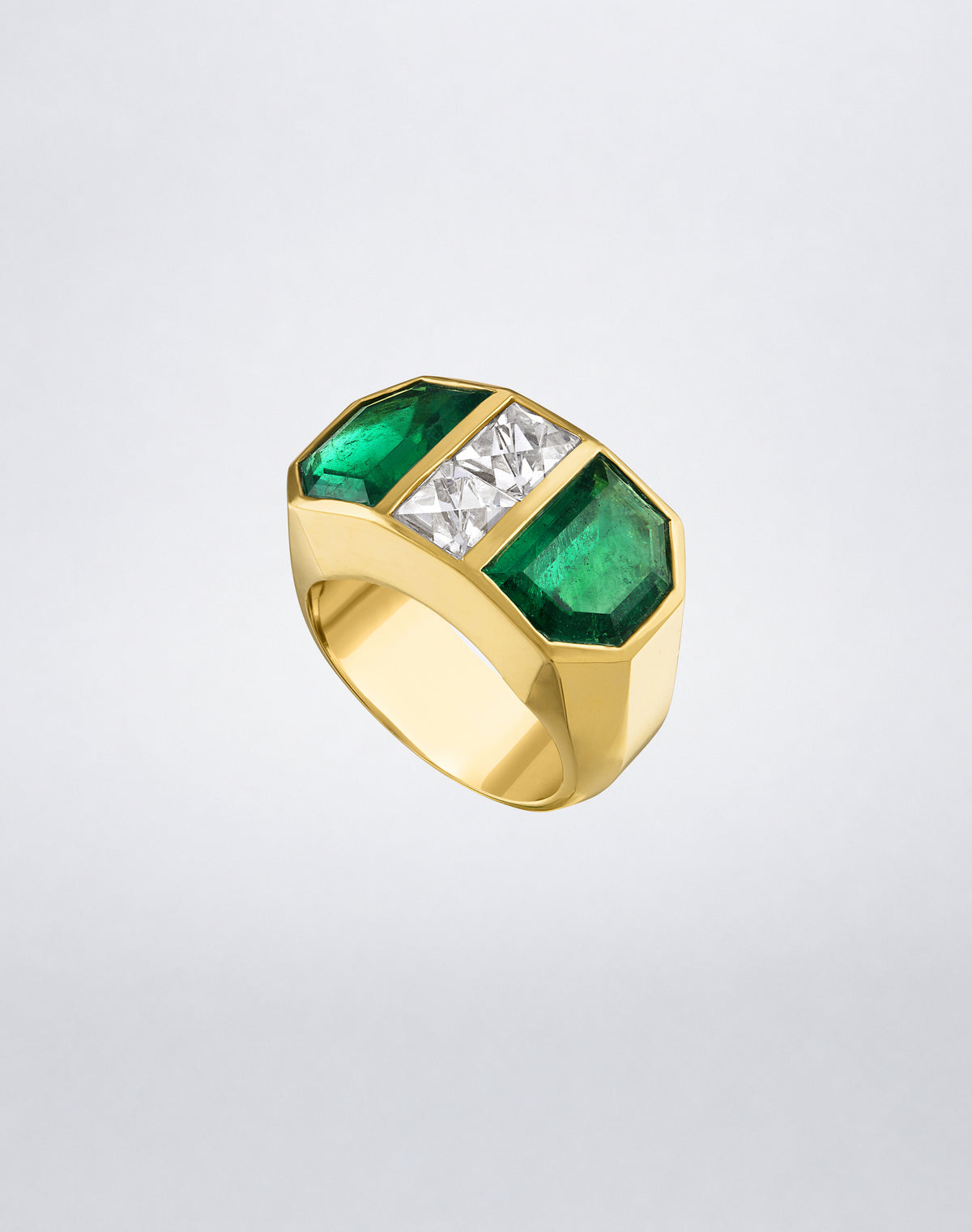 Angled view of the Mindi Mond New York Colombian Emerald Shield and French-Cut Diamond Ring with two emerald shields and central diamonds.
