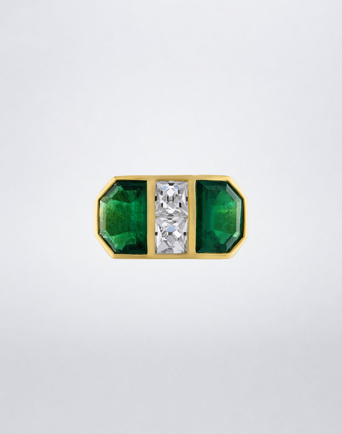 Front view of the Mindi Mond New York Colombian Emerald Shield and French-Cut Diamond Ring with symmetrical emeralds and two central diamonds.