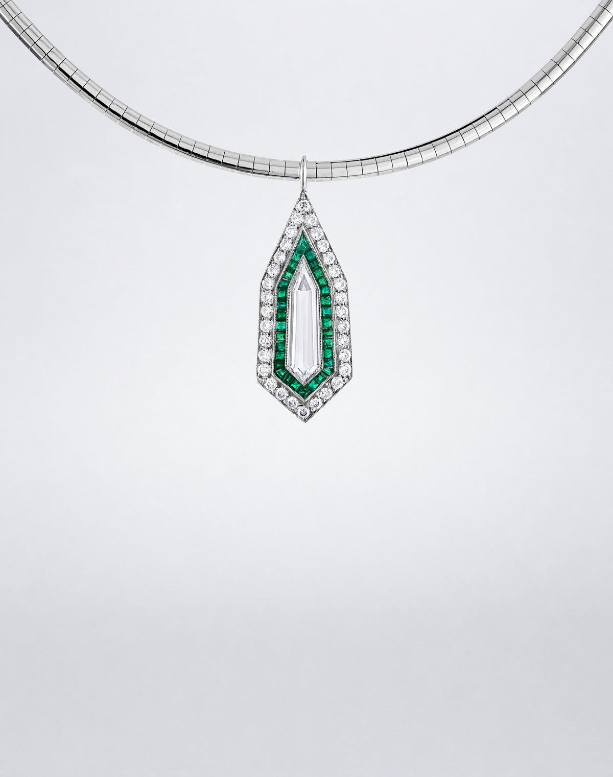 Detail view of the Mindi Mond New York ICONS Diamond Kite Emerald Pendant Necklace with a central diamond framed by emeralds and diamonds in 18K white gold.