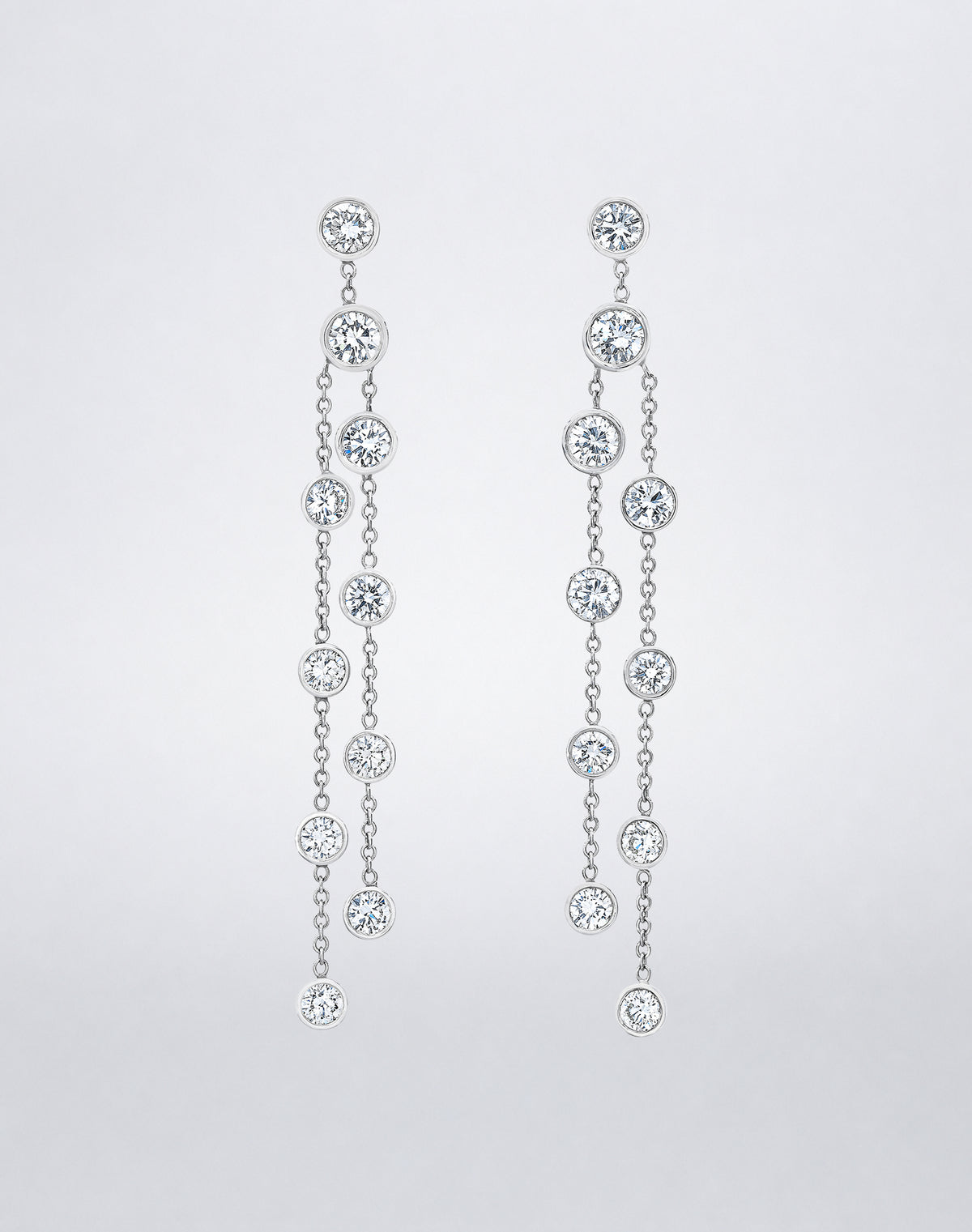 Mindi Mond New York ICONS Dripping Diamond Earrings in 18K white gold, front view featuring bezel-set round diamonds cascading from delicate chains.