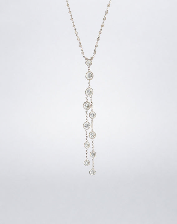 Detail view of the Mindi Mond New York ICONS Dripping Diamonds Necklace with graduated bezel-set diamonds suspended from fine diamond-set chains.