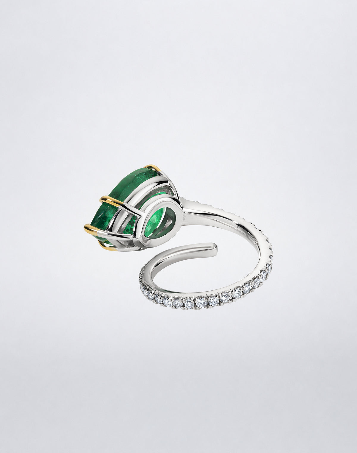 Detail view of Mindi Mond New York Emerald and Diamond Single Spiral Ring showing the open spiral setting and pavé diamond band.