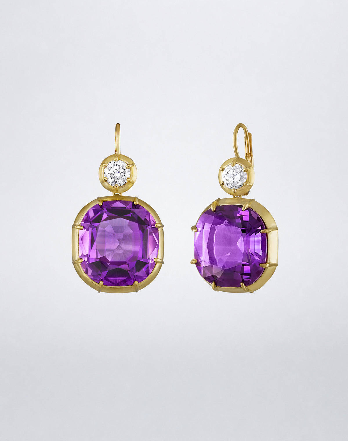 Side view of the Mindi Mond New York ICONS Imperial Amethyst Diamond Drop Earrings in 18K yellow gold, highlighting the cushion-cut amethyst setting and leverback closure.