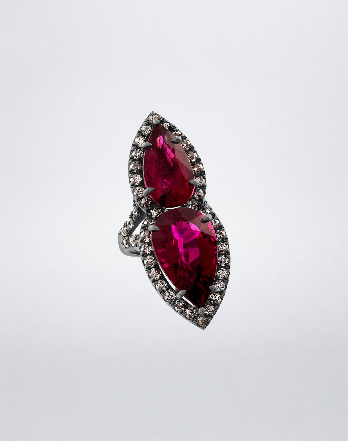 Mindi Mond New York Kissing Rubellite Ring with two pear-shaped rubellites framed by diamonds in 18K blackened gold, angled view.