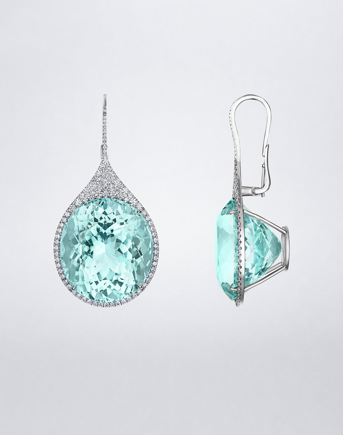 Side view of Mindi Mond New York ICONS Paraiba Tourmaline Earrings in 18K white gold, highlighting the raised oval-cut tourmaline setting and diamond frame.