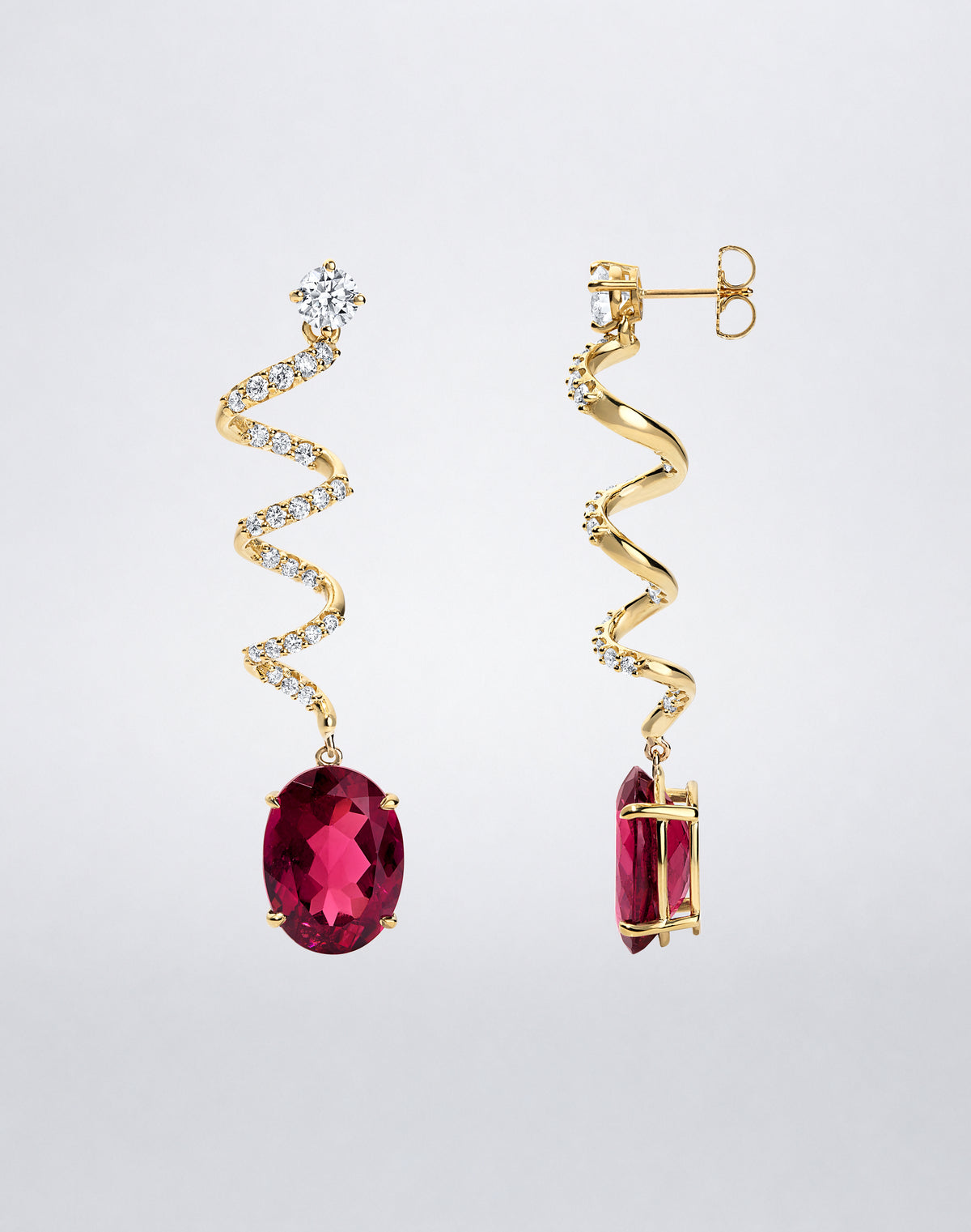 Side view of Mindi Mond New York ICONS Rubellite Diamond Spiral Earrings in 18K yellow gold, showing the oval rubellite drops and dimensional diamond spiral design.