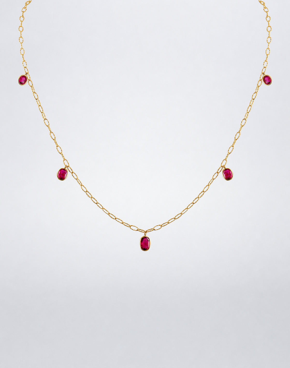 Mindi Mond New York Ruby 5 Drop Tinsel Chain Necklace with five bezel-set ruby drops suspended from an 18K yellow gold tinsel chain.