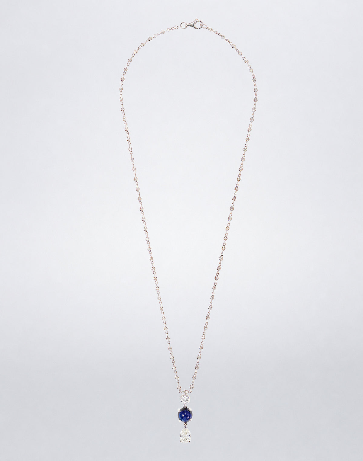 Mindi Mond New York Sapphire Dangling Diamond Pendant Necklace on a diamond-set 18K white gold chain with blue sapphire and diamond drops.