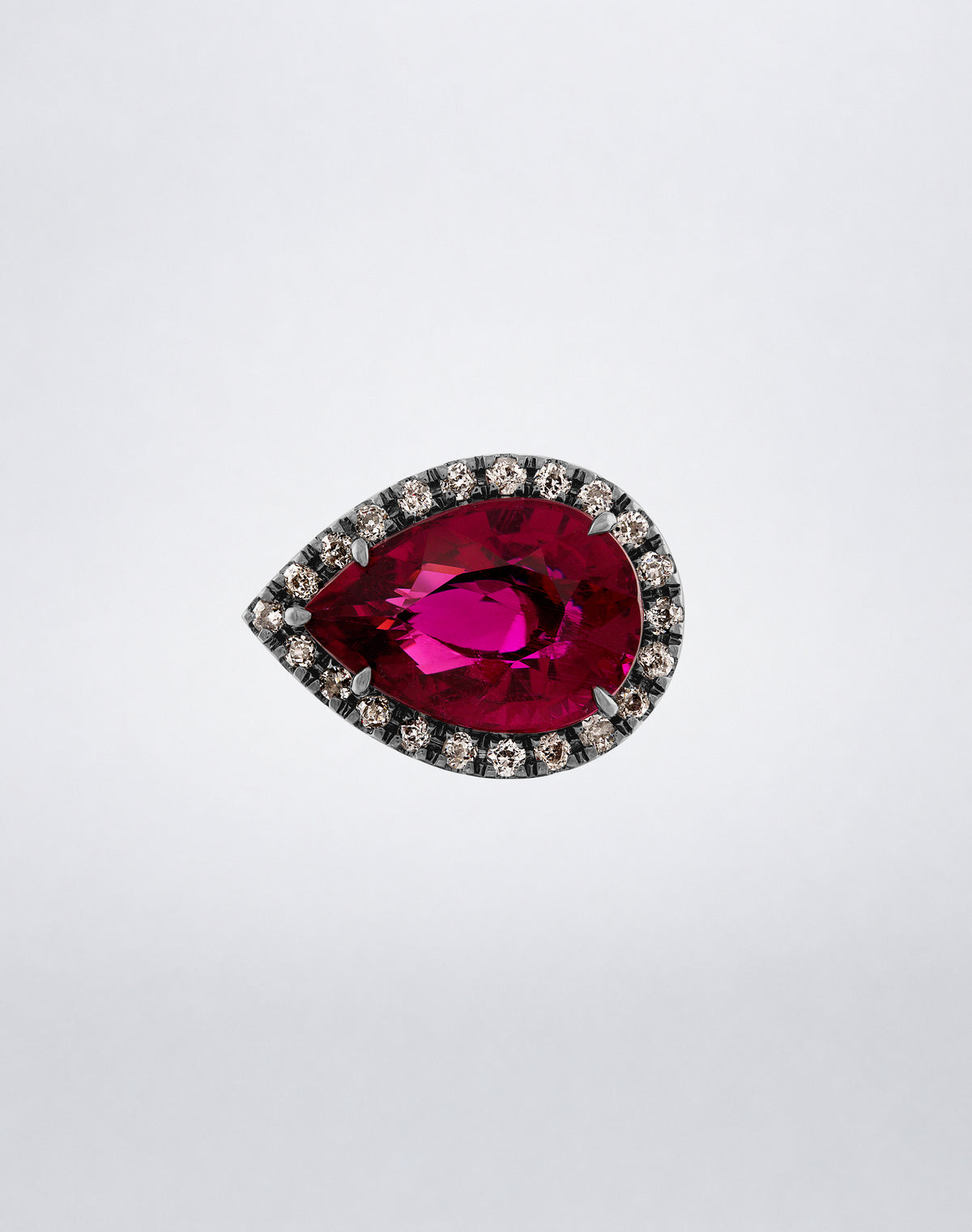 Mindi Mond New York Side Pear Rubellite Ring with vivid rubellite framed by diamonds in rhodium-finished 18K blackened gold, front view.