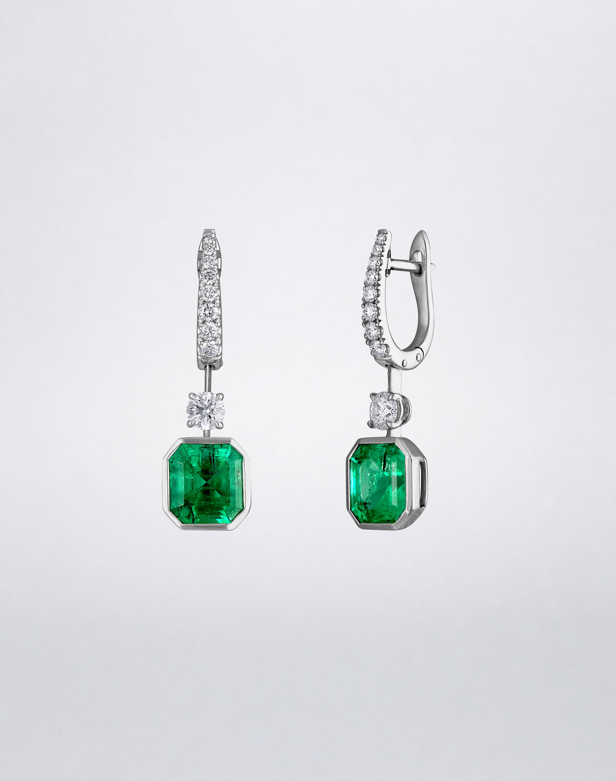 Side view of Mindi Mond New York ICONS Suspended Gemstone and Diamond Earrings in 18K white gold, highlighting the emerald drops, diamond connectors and pavé setting.