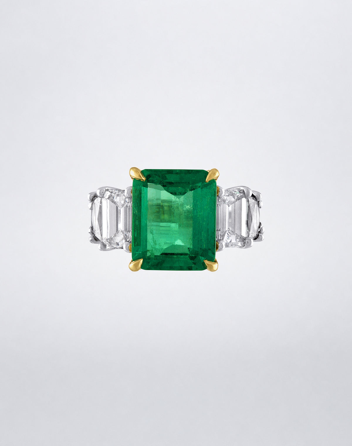 Mindi Mond New York Triple Step Colombian Emerald Ring with a Colombian emerald center and step-cut diamond side stones in gold and platinum, front view.