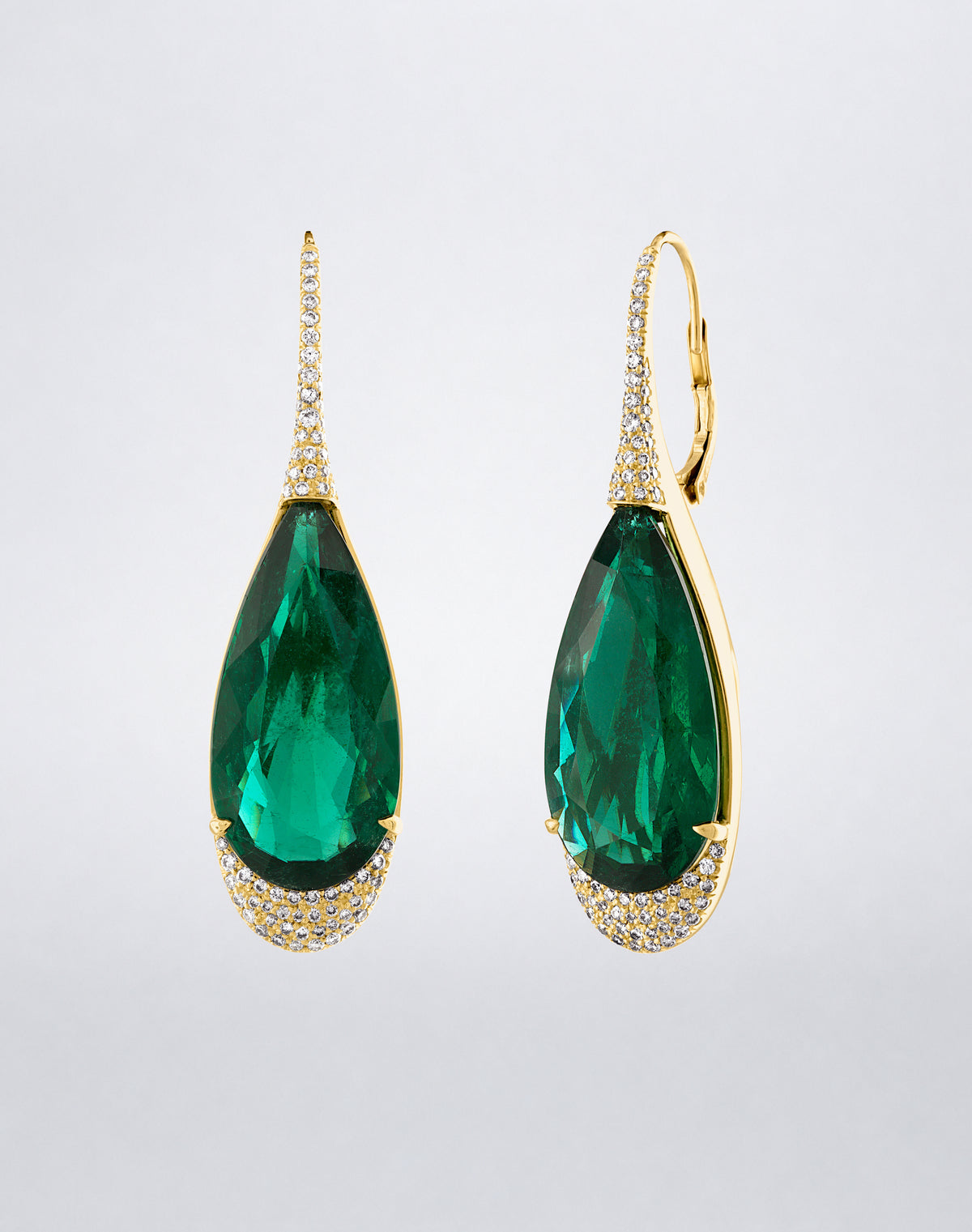 Side view of Mindi Mond New York ICONS Zambian Emerald and Diamond Drop Earrings in 18K yellow gold, highlighting the sculptural emerald setting, pavé diamonds and leverback closure.