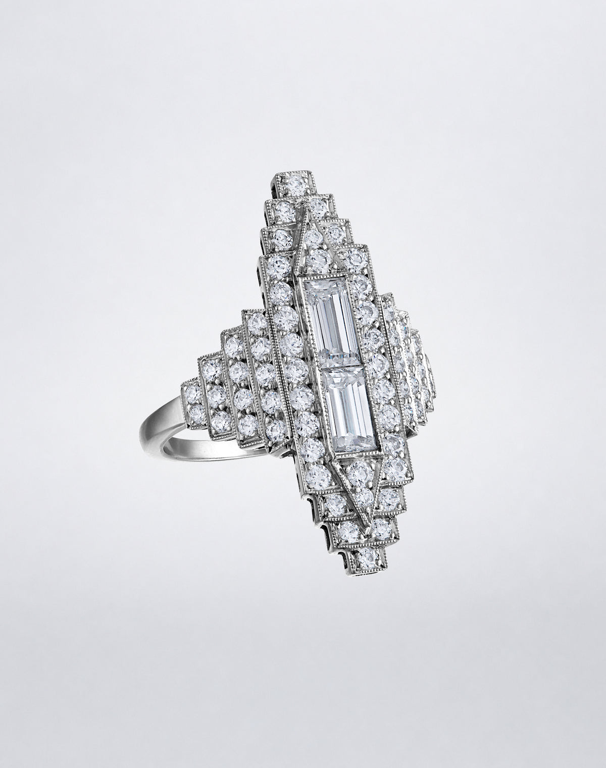 Angled view of the one-of-a-kind All Diamond Empire Ring showing layered geometric diamond settings and elongated baguette center stones.