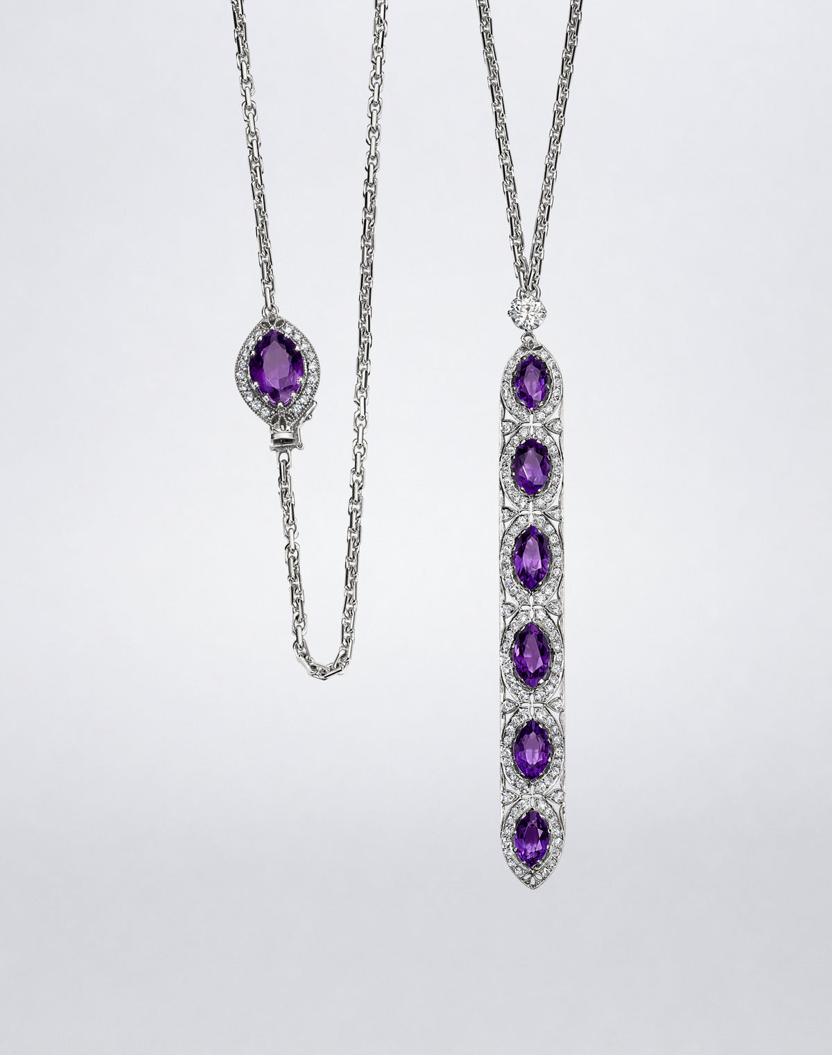 Full view of the one-of-a-kind sautoir showing its white metal chain, elongated amethyst and diamond pendant, and decorative amethyst clasp.