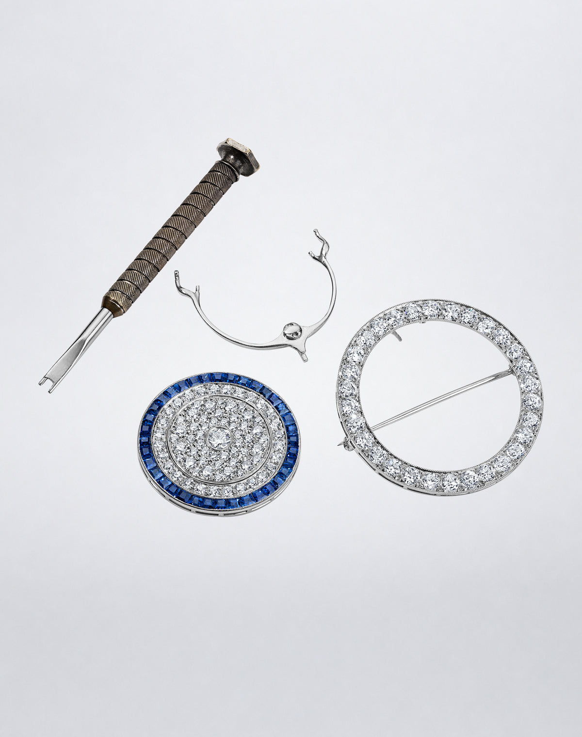 Detail view of the one-of-a-kind RECONCEIVED Celestial Diamond and Sapphire Brooch shown with its removable components and setting tool.